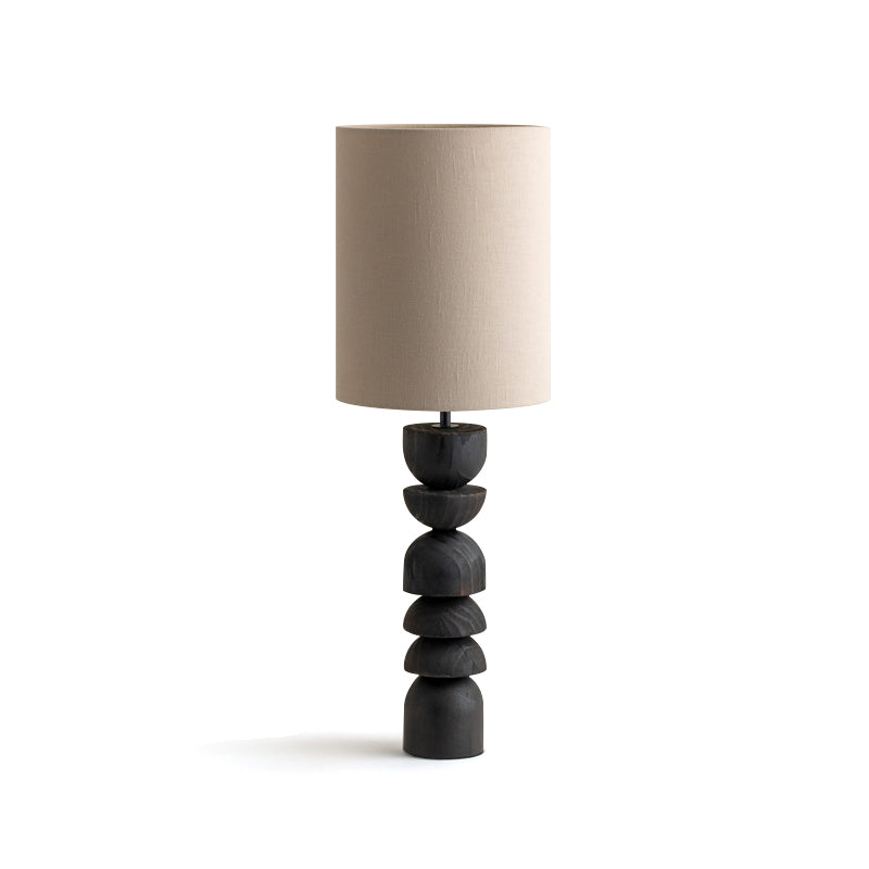 Compact Sergio sculptural table lamp with blackened carved wooden base and beige linen shade