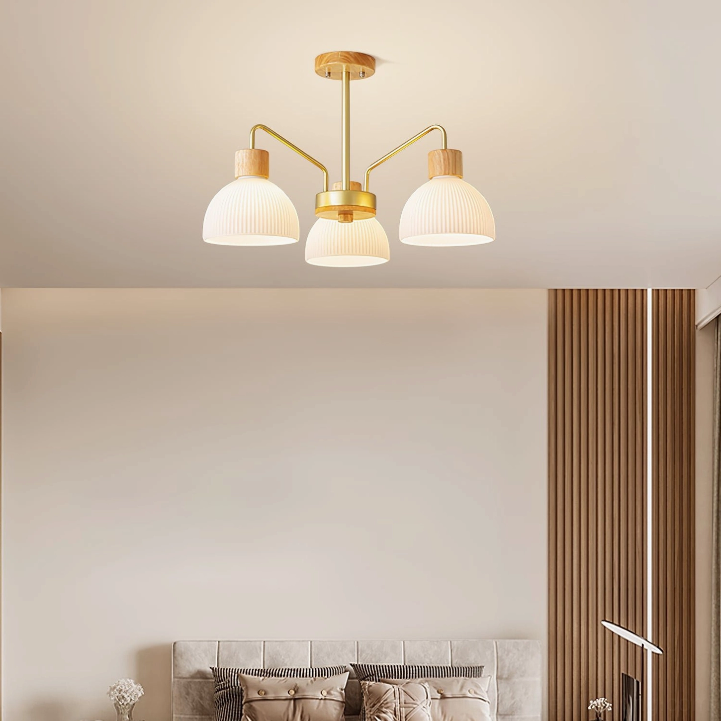 3-head ribbed glass chandelier with gold metal base and pleated white shades, flat overhead studio shot