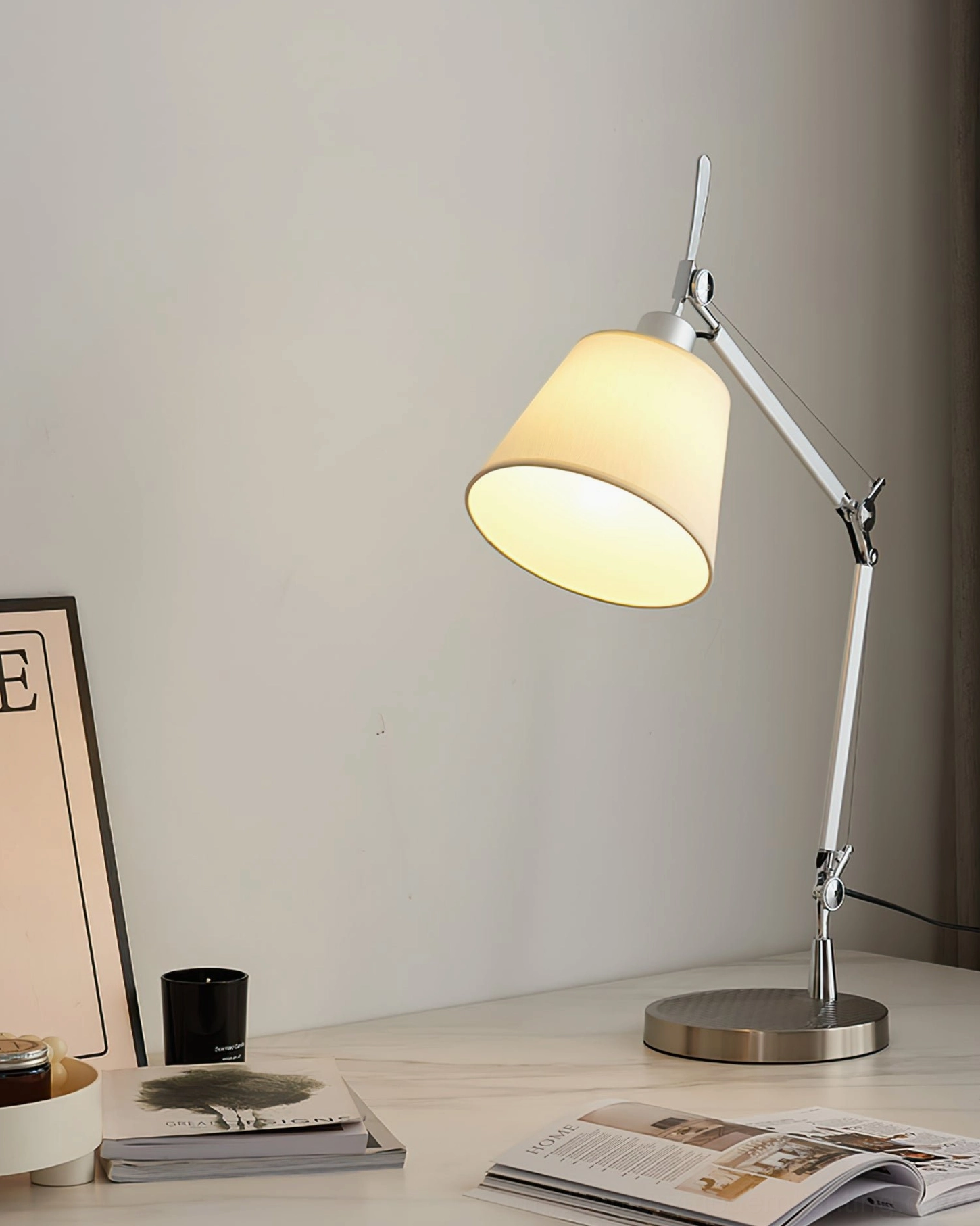 Modern adjustable articulated table lamp with silver metal construction and white fabric shade for mid-century contemporary interiors