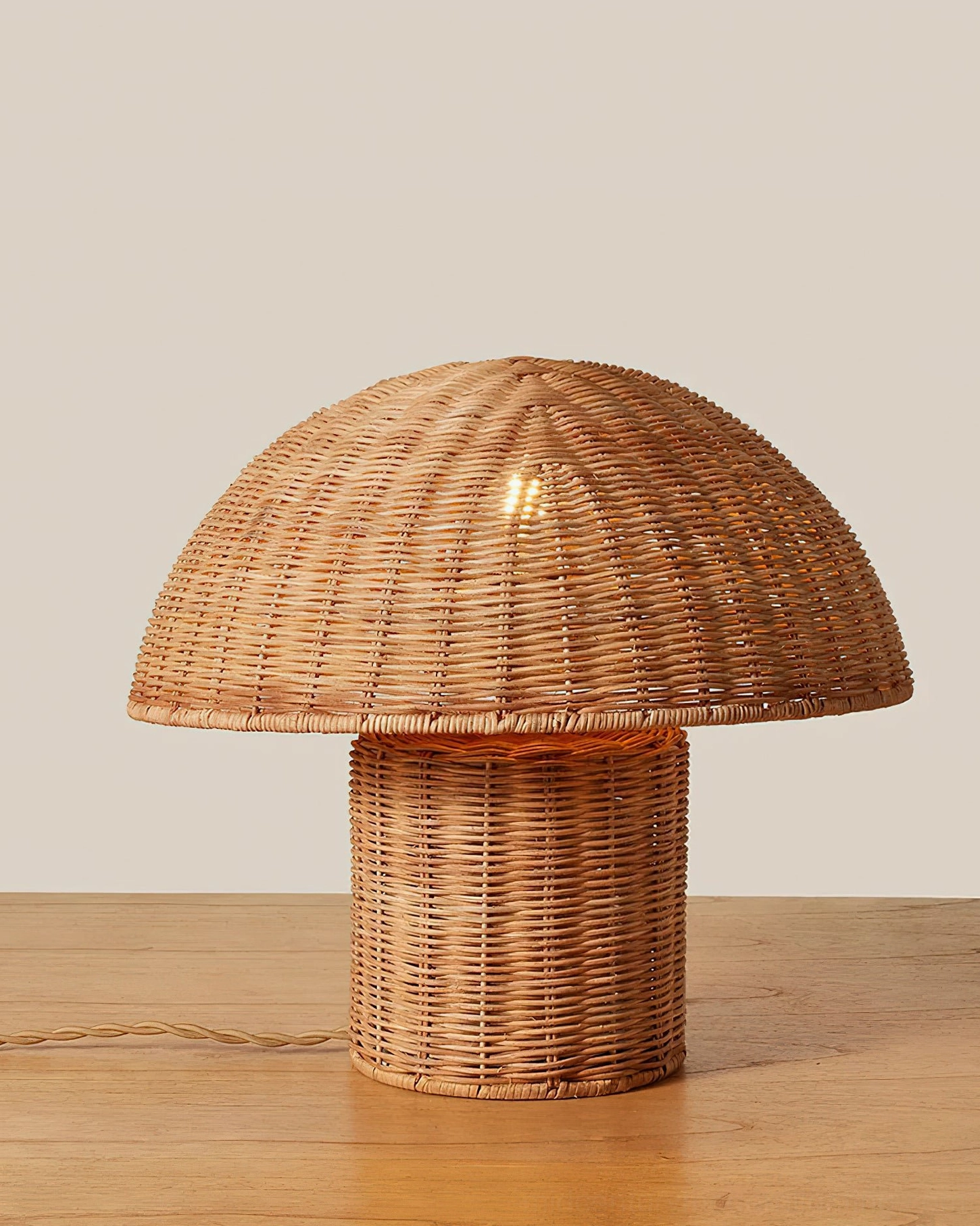 Aero rattan mushroom table lamp front view on wooden surface showing detailed hand-woven rattan craftsmanship