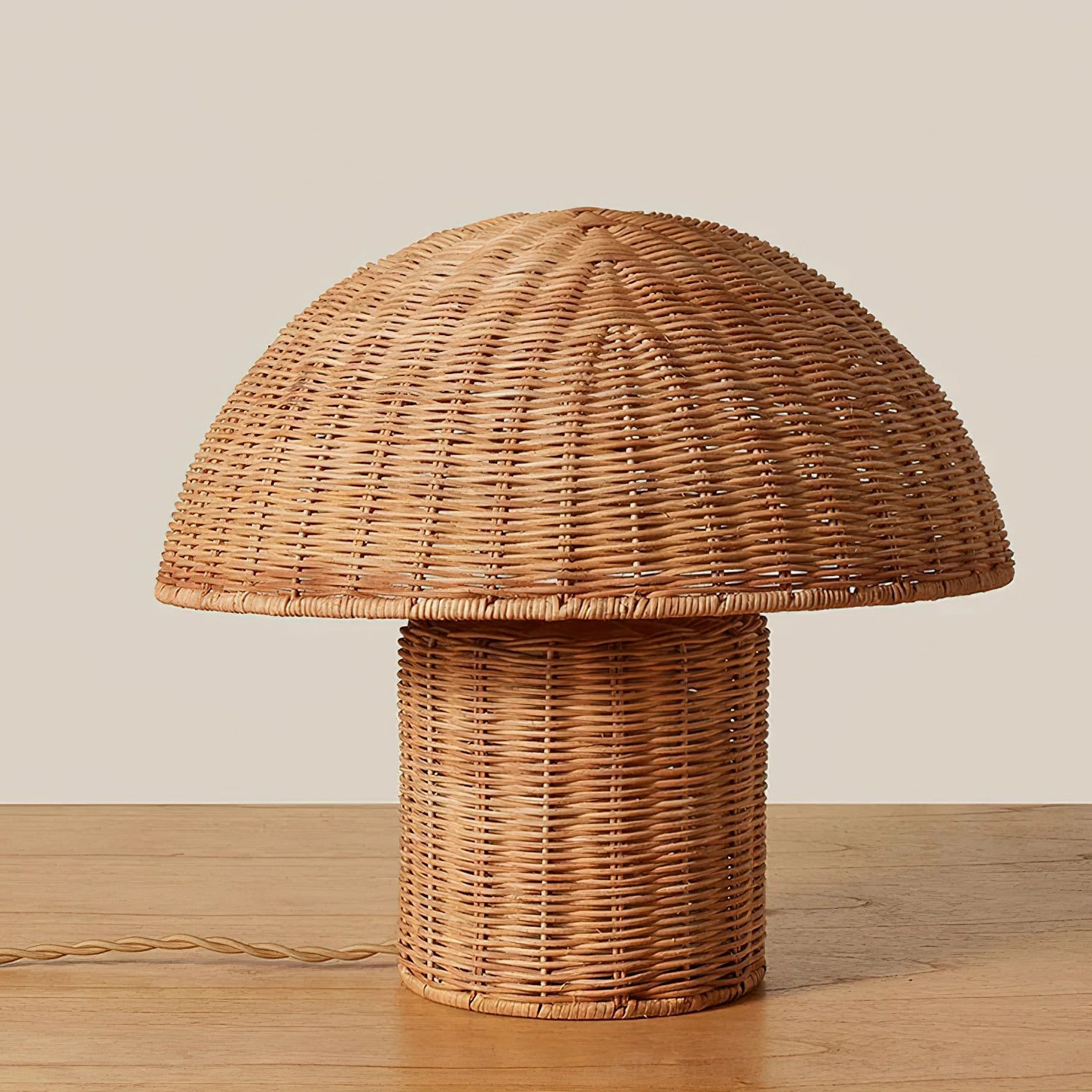 Aero rattan mushroom lamp three-quarter angle showcasing hand-woven rattan details and gold metal frame