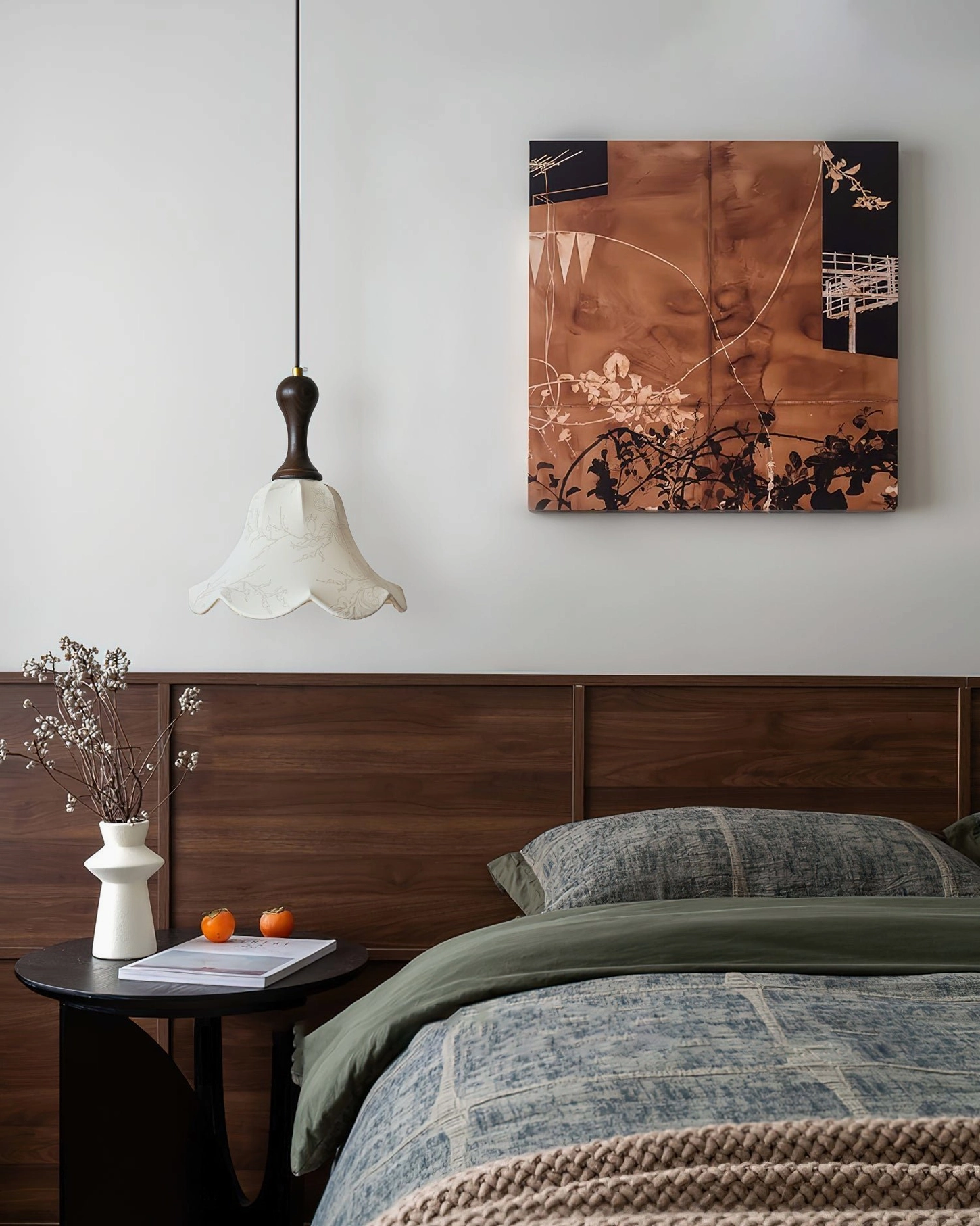 Agnes pendant light illuminated above wooden bed in vintage bedroom setting with wall art
