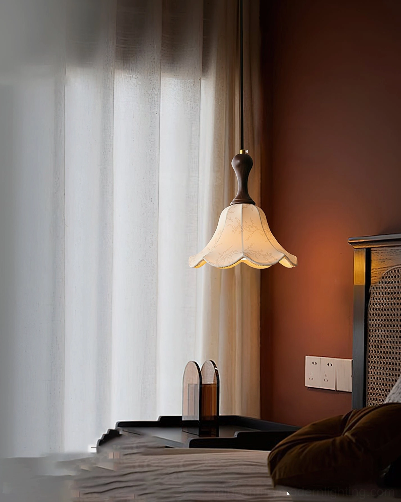 Agnes pendant light suspended in indoor space with terracotta wall and sheer fabric curtains