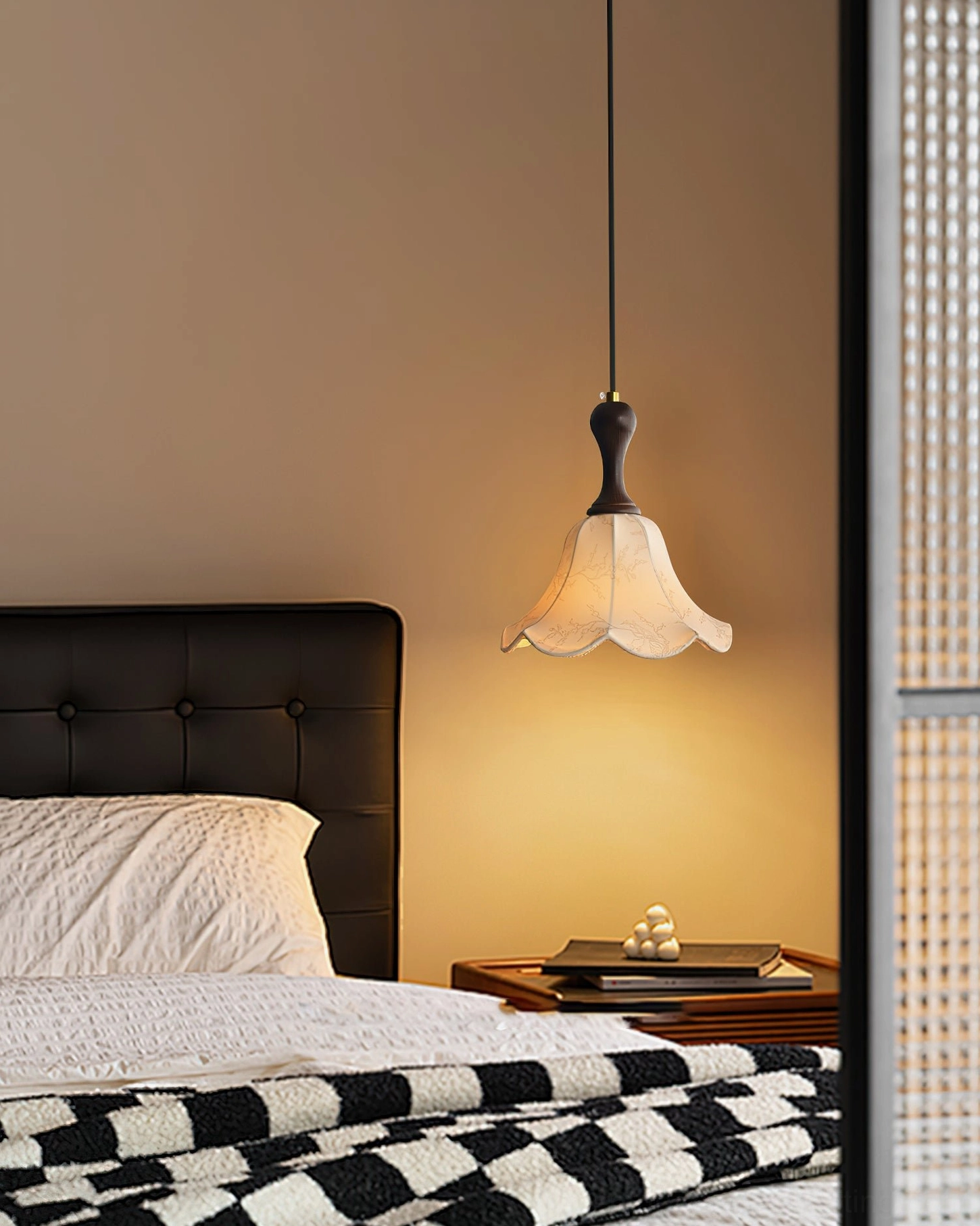 Agnes pendant light providing cozy warm glow above minimalist nightstand in bedroom