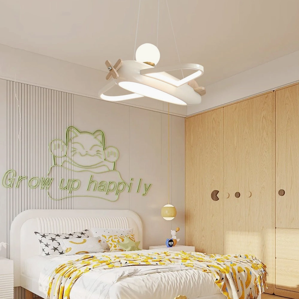 Aircraft pendant lamp in warm neutral kids bedroom with wooden wardrobes and wall decals