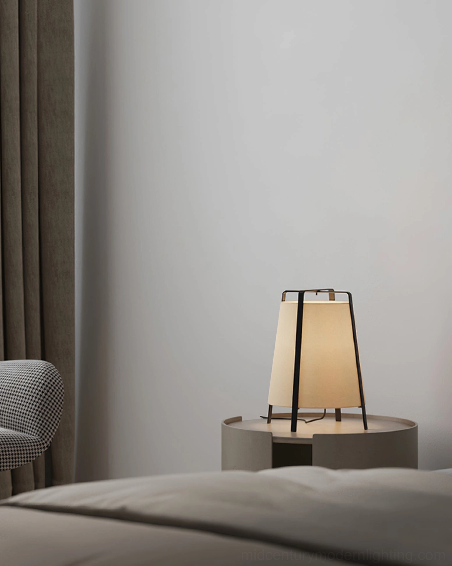 Small Akane table lamp on bedroom bedside round table with metal frame and conical shade, three-quarter front angle