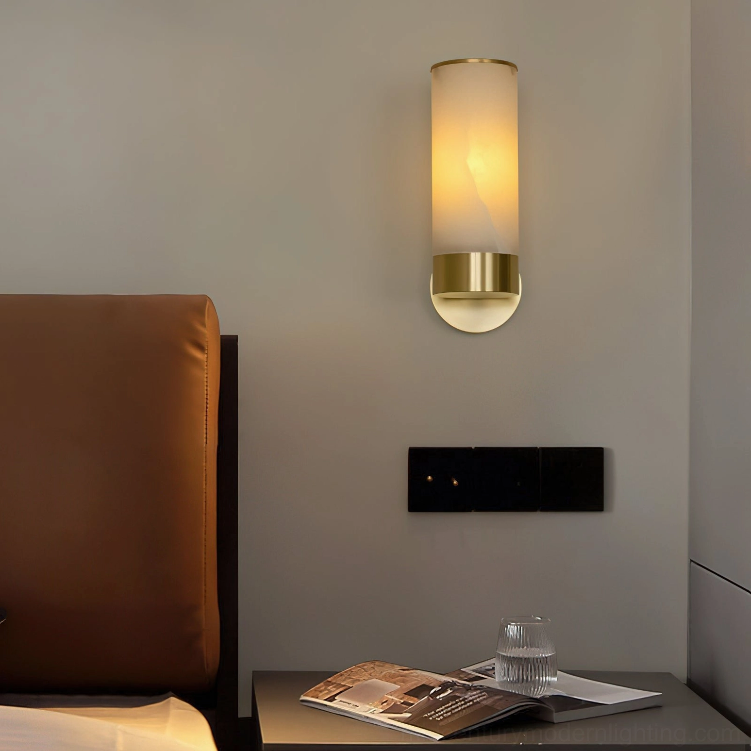 Alabaster wall sconce complete view showing cylindrical shade geometry, refined collar design, and wall-mounted installation