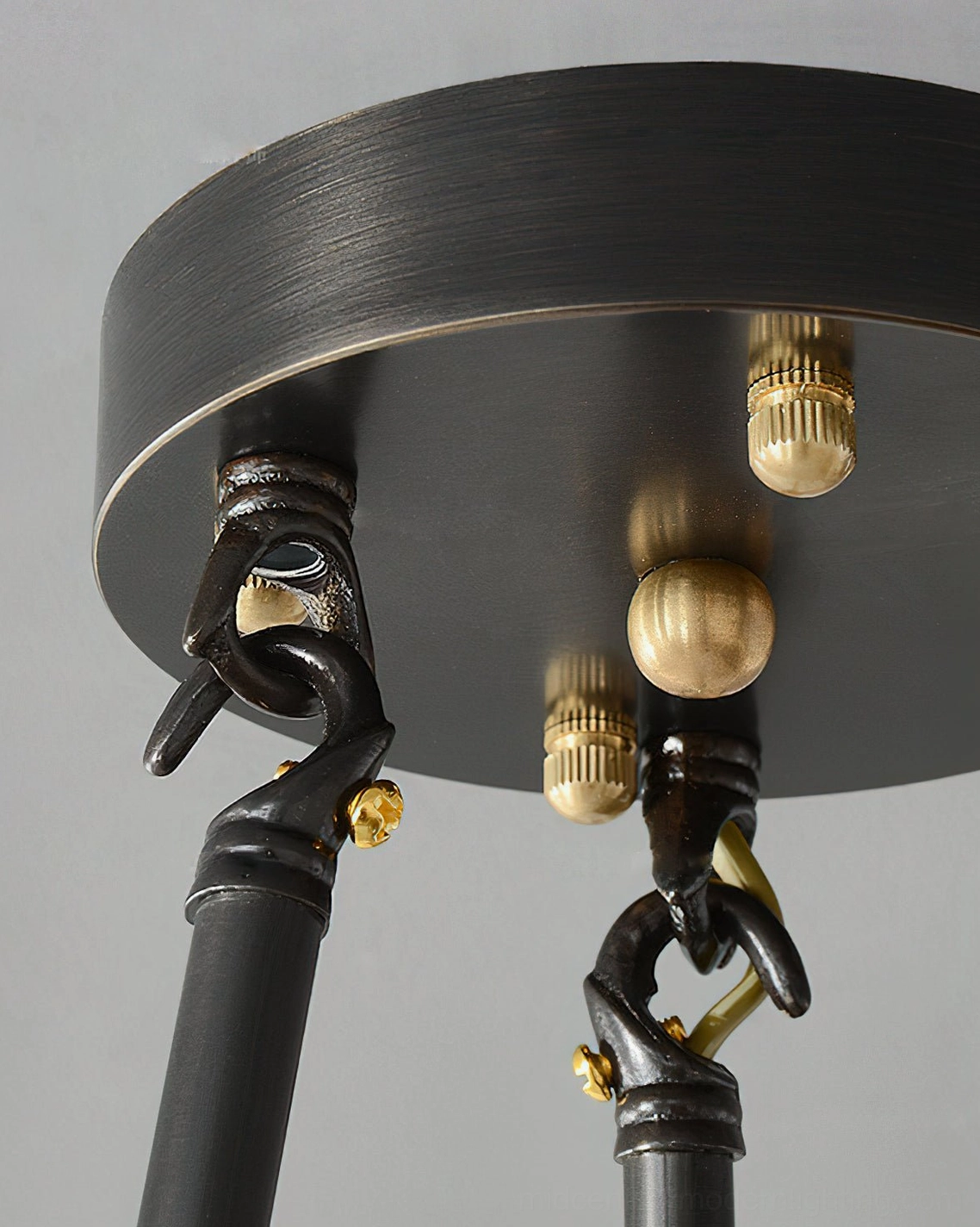 Brass ceiling hardware and mounting plate close-up for alabaster pendant installation