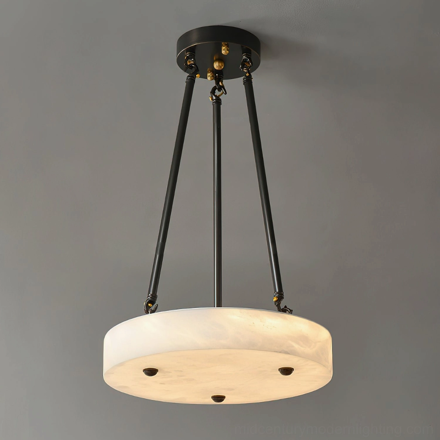 Lit alabaster pendant with warm ambient glow showing mounting hardware details