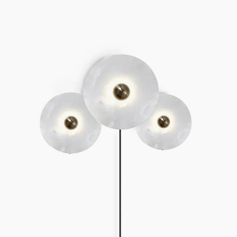 Plug-in alabaster wall lamp showing bronze brass fixture hardware and cord assembly detail