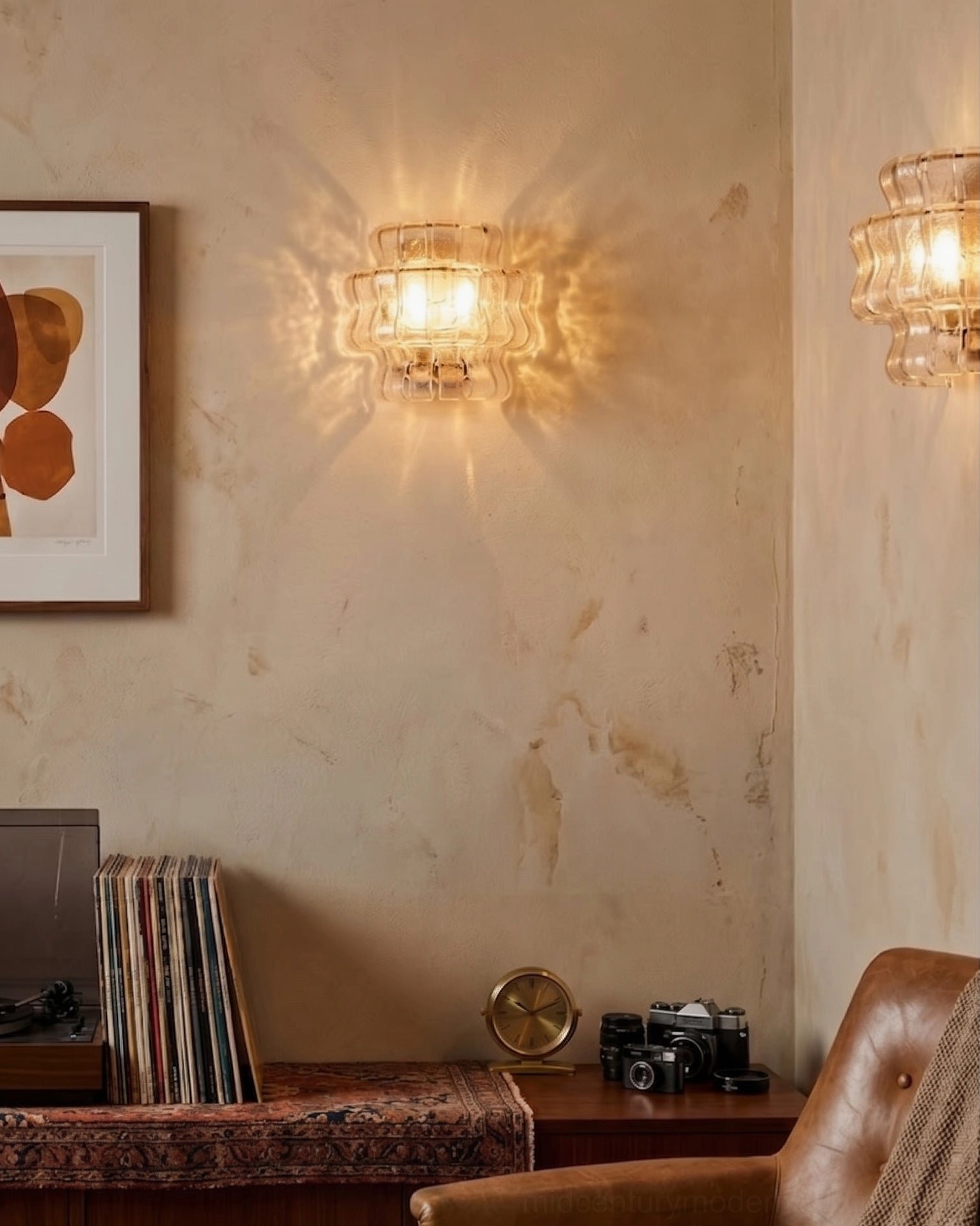 Albano mid-century modern sconce mounted above console table in elegant entryway