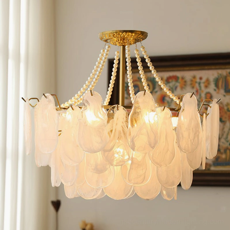 Close-up frosted glass petal chandelier bright glowing warm lights dense shade detail
