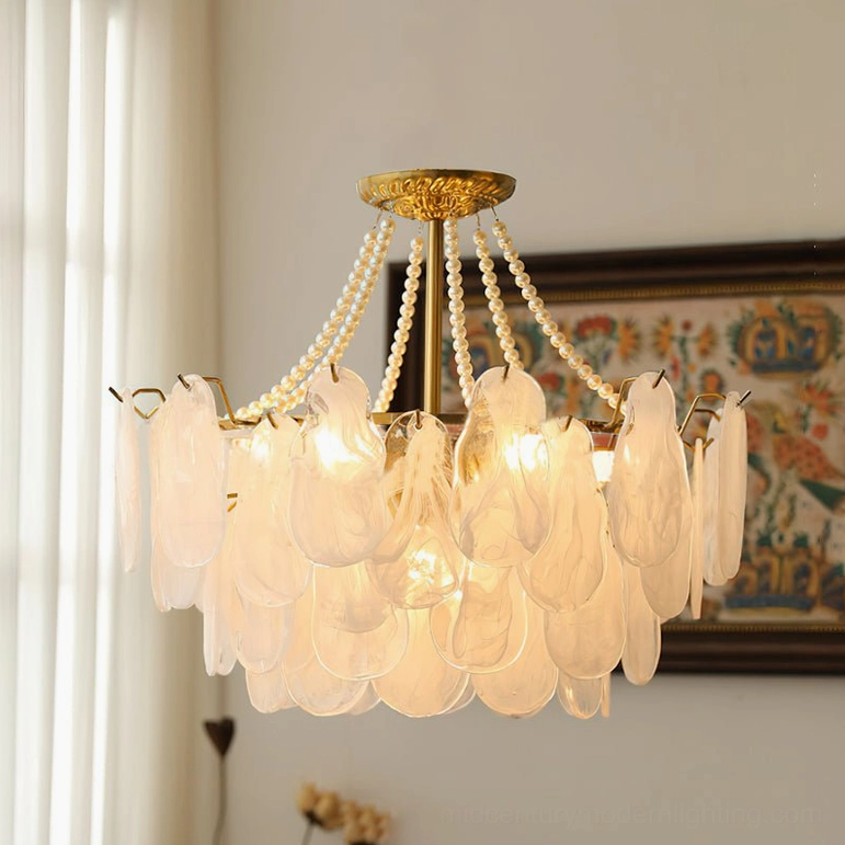 Illuminated frosted petal chandelier with warm glowing bulbs and pearl chain accents