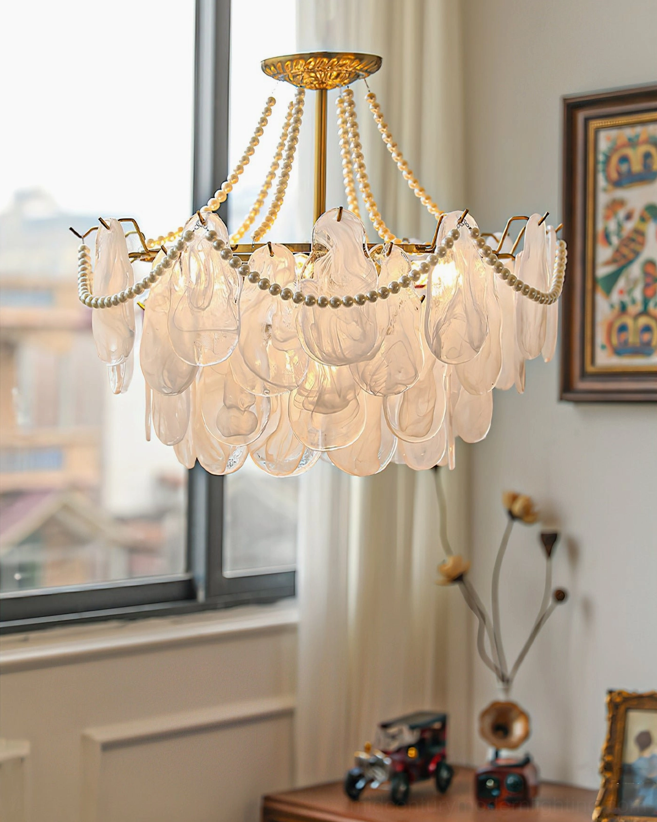 Elegant frosted glass chandelier three-quarter angle near decorative furnishings and window