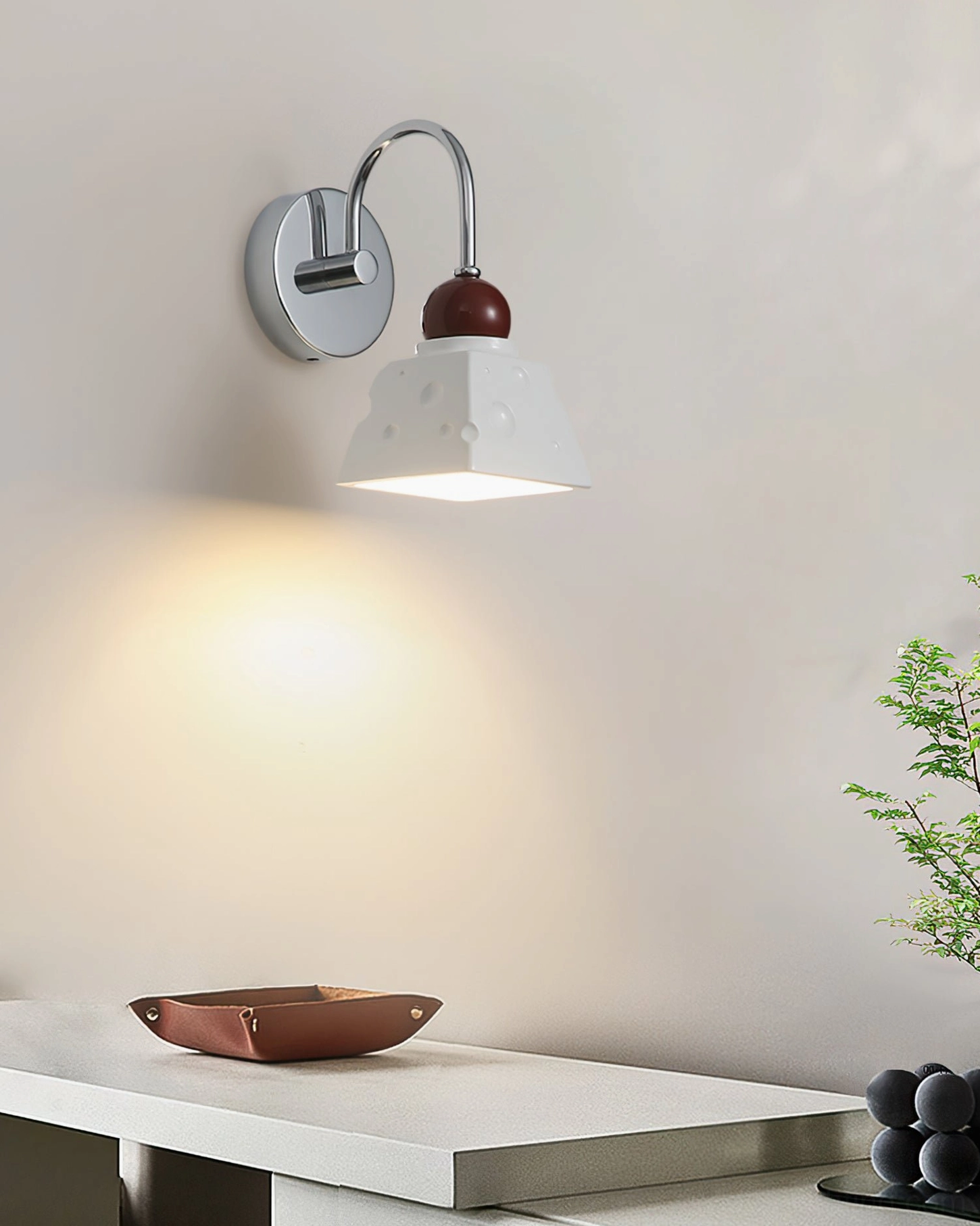 Alma mid-century modern wall sconce, polished chrome finish with resin diffuser