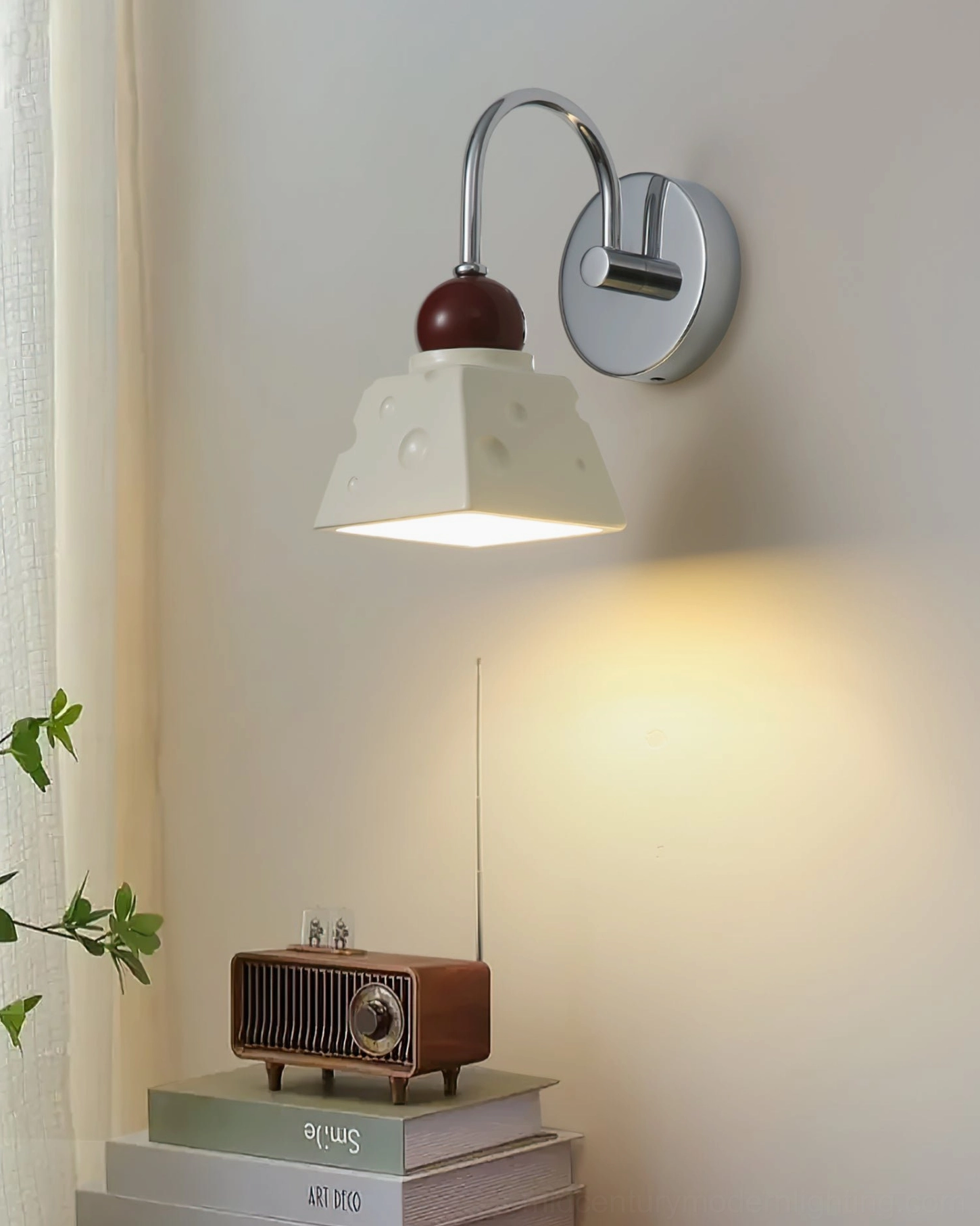 Alma LED wall sconce detail shot showing metal frame construction and resin material