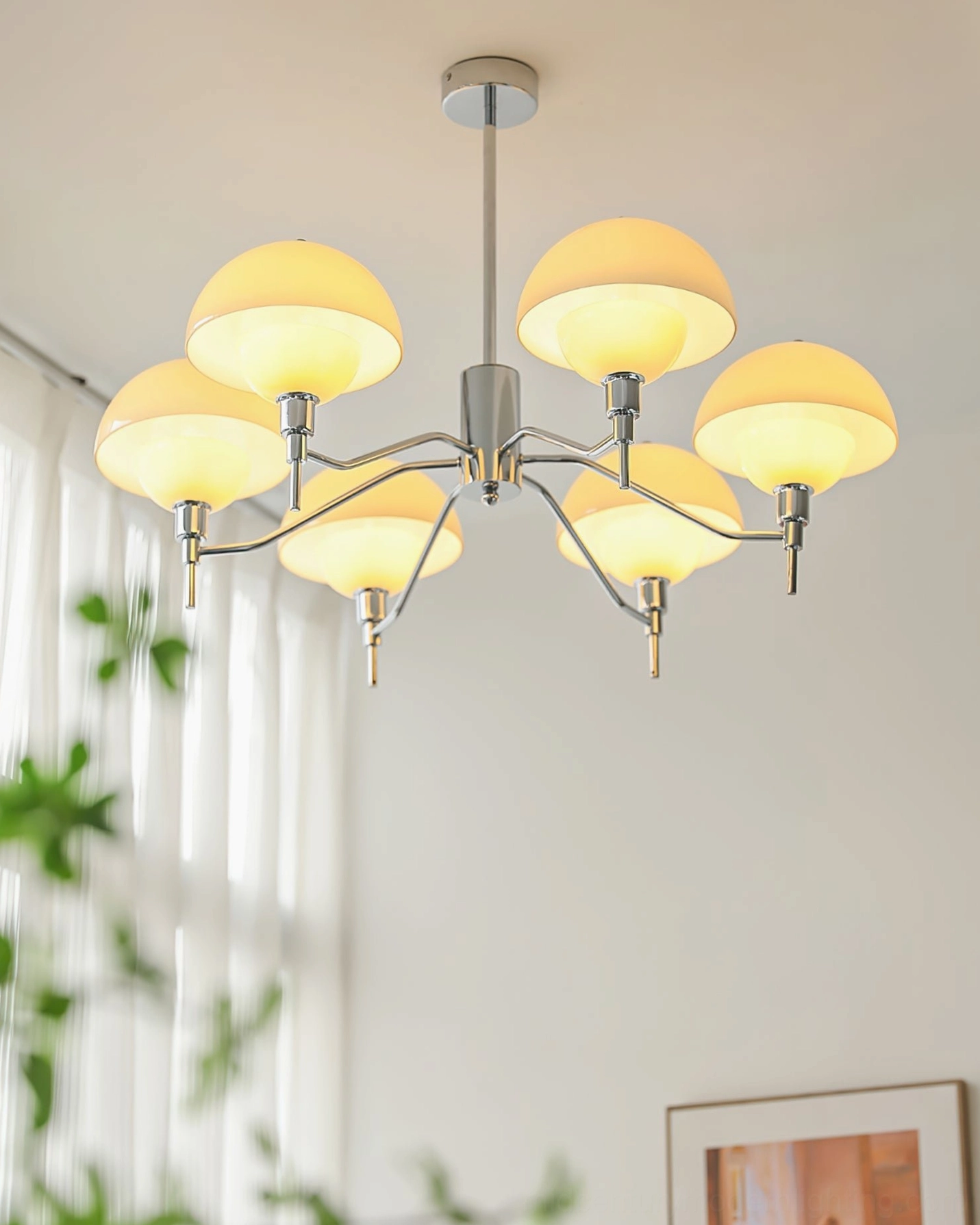 5-arm chrome ceiling chandelier overhead angled view bright living room sheer curtains