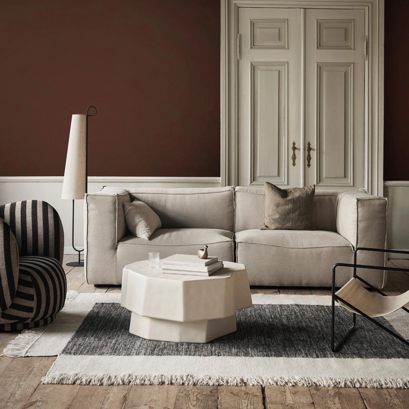 Ancora floor lamp with black metal stand in contemporary minimalist bedroom setting with neutral tones