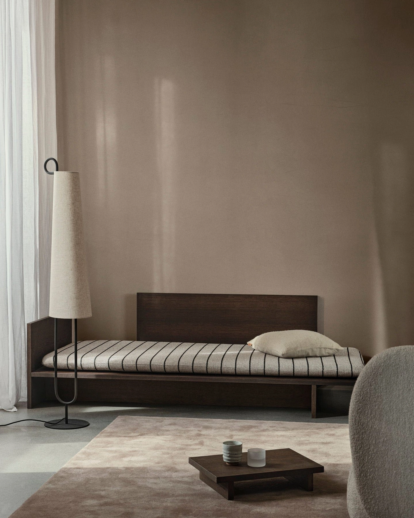 Ancora modern floor lamp illuminating reading space with soft directional lighting and minimalist aesthetic