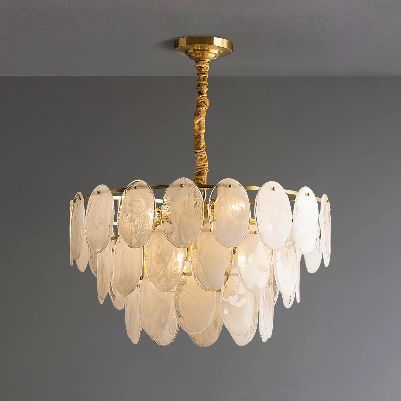 Contemporary tiered glass chandelier three-quarter front view minimalist background brass hanging rod