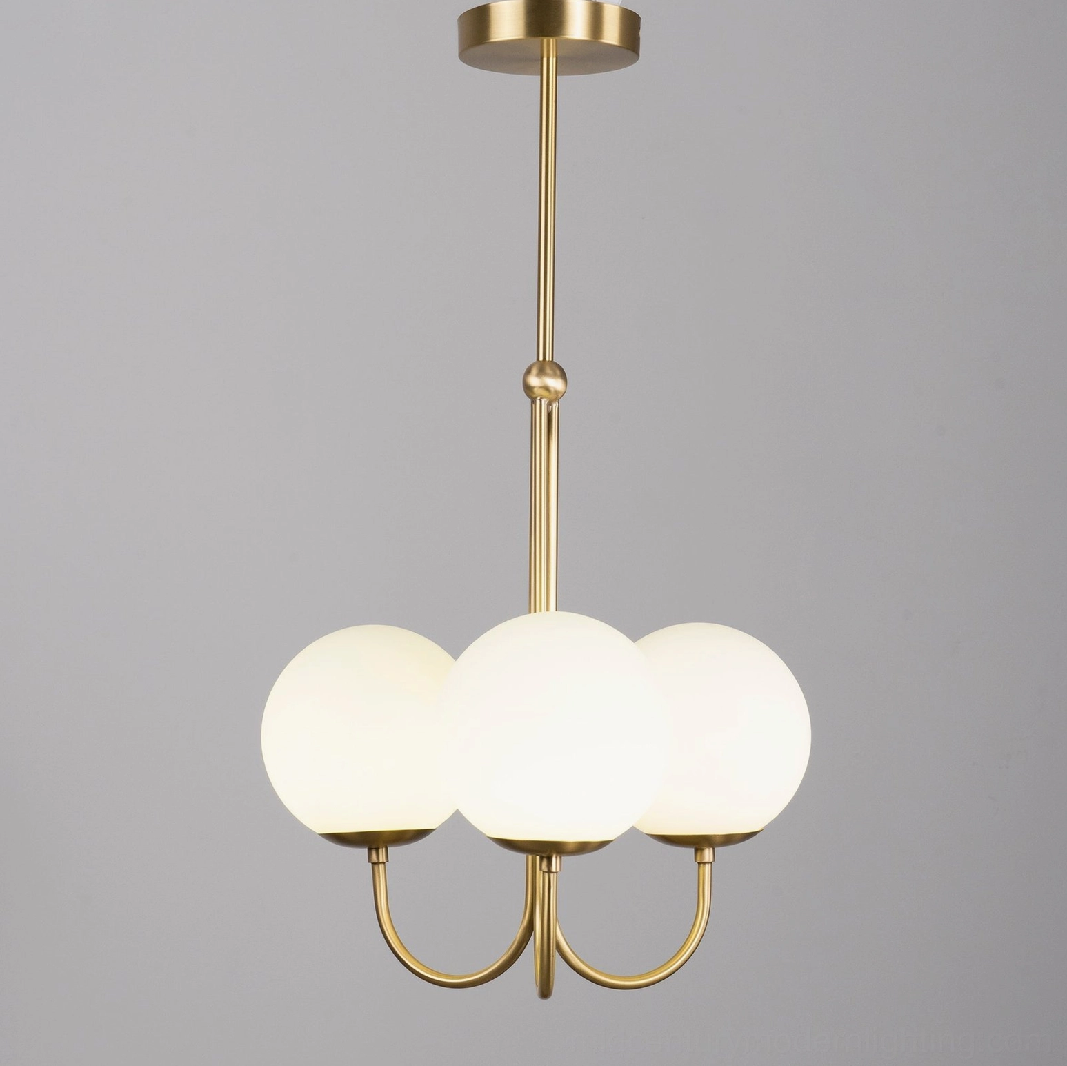 2-head frosted glass globe pendant with polished brass mounting and geometric arms design detail