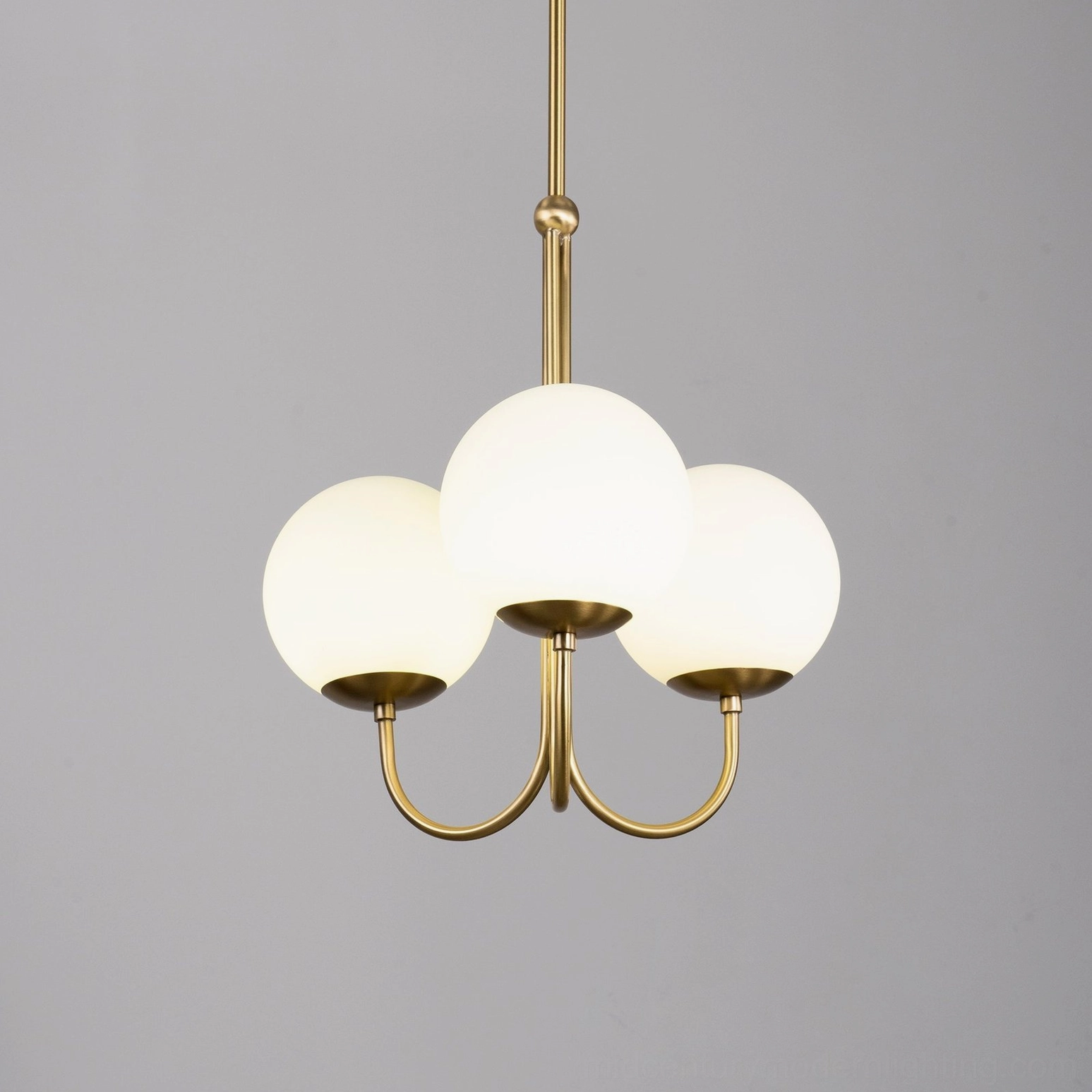 Angle mid-century modern chandelier full product view with brass frame and frosted glass globes