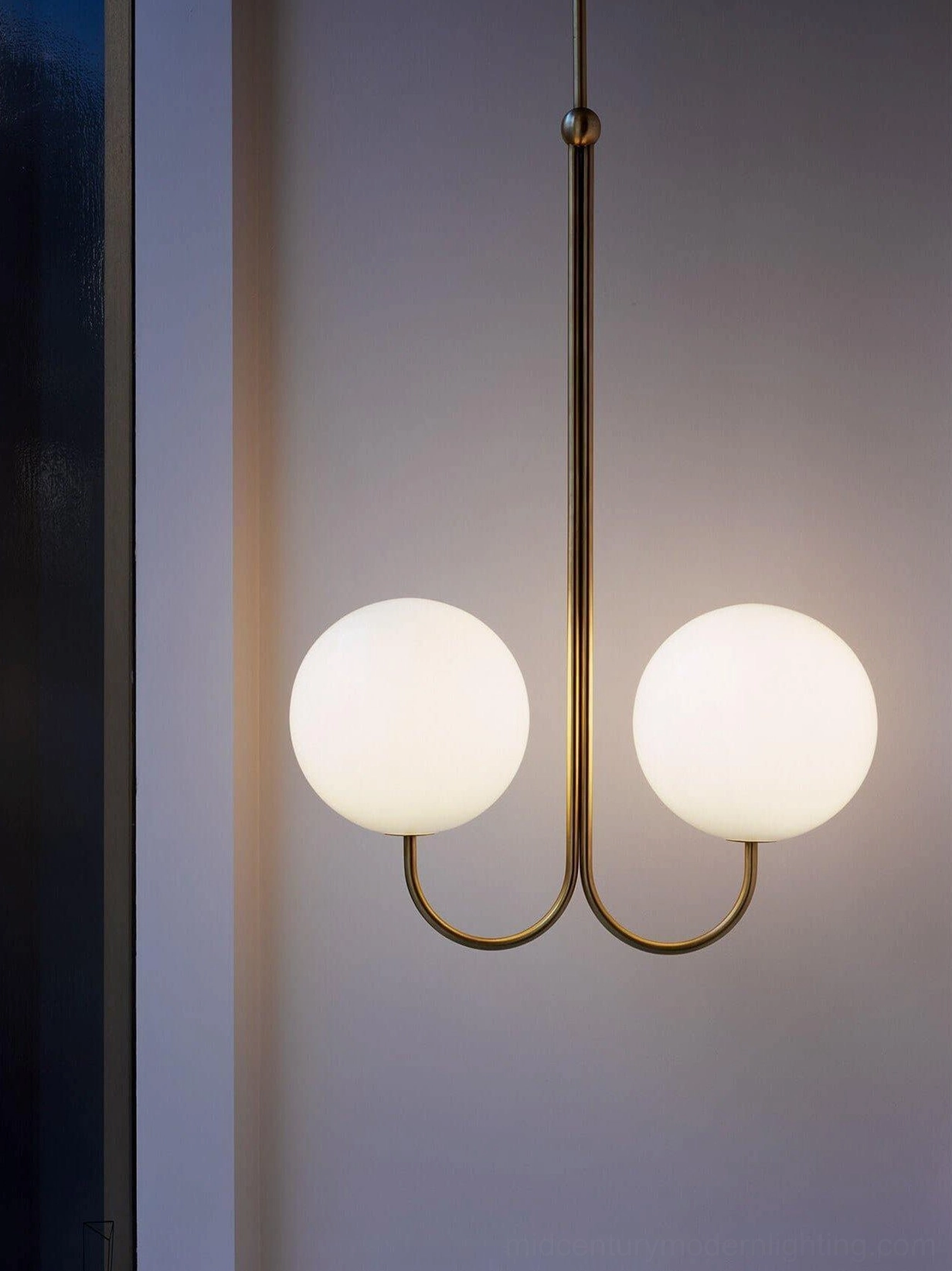 Angle chandelier with multiple frosted glass globes and polished brass frame contemporary styling
