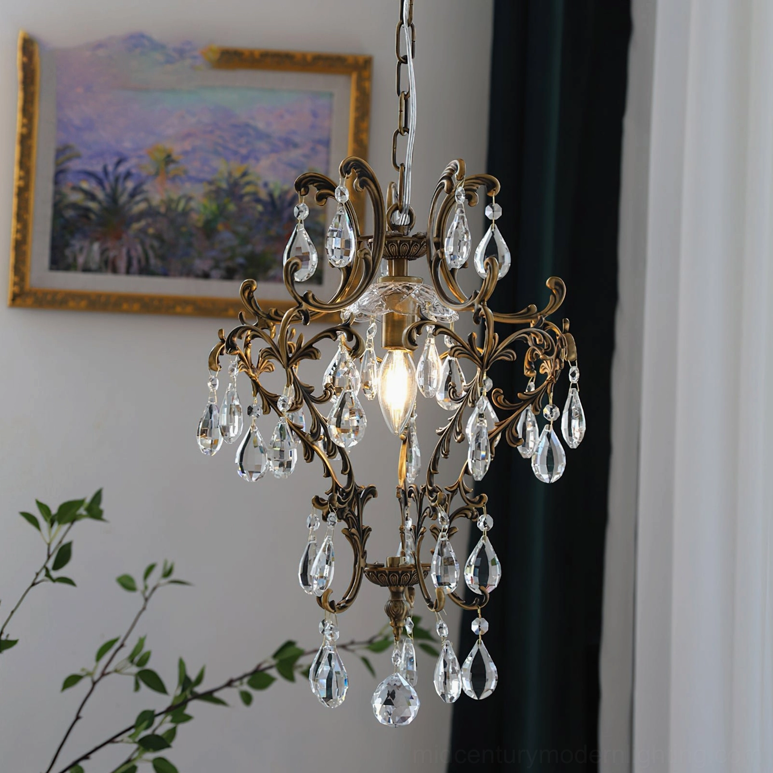 Antique crystal birdcage pendant with ornate design suspended from adjustable chain in home setting