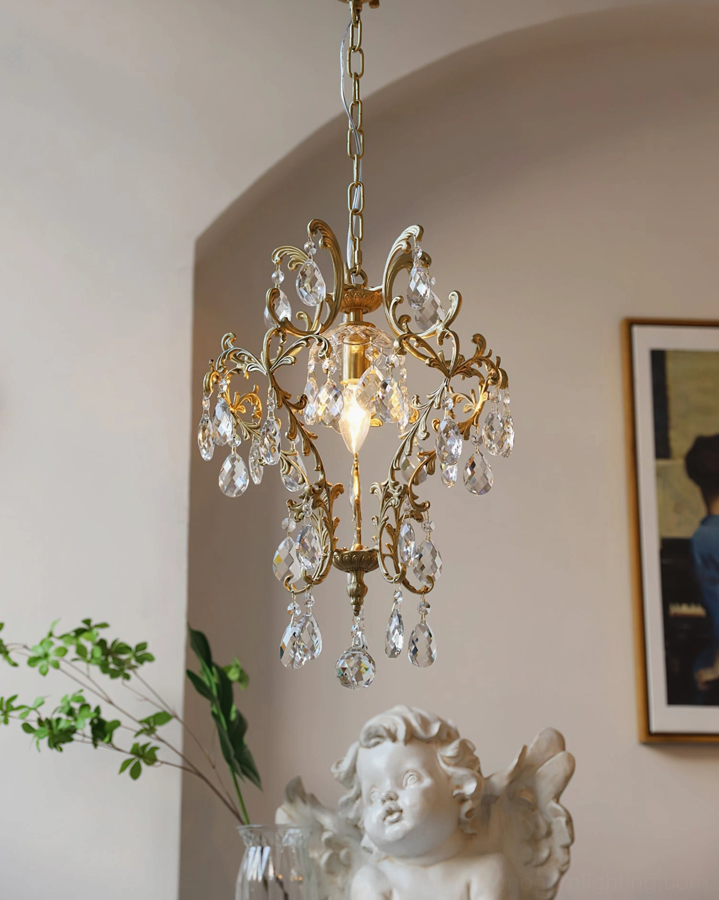 Antique gold-finish birdcage chandelier with delicate scroll design and abundant crystal pendants in cozy vintage ambiance setting
