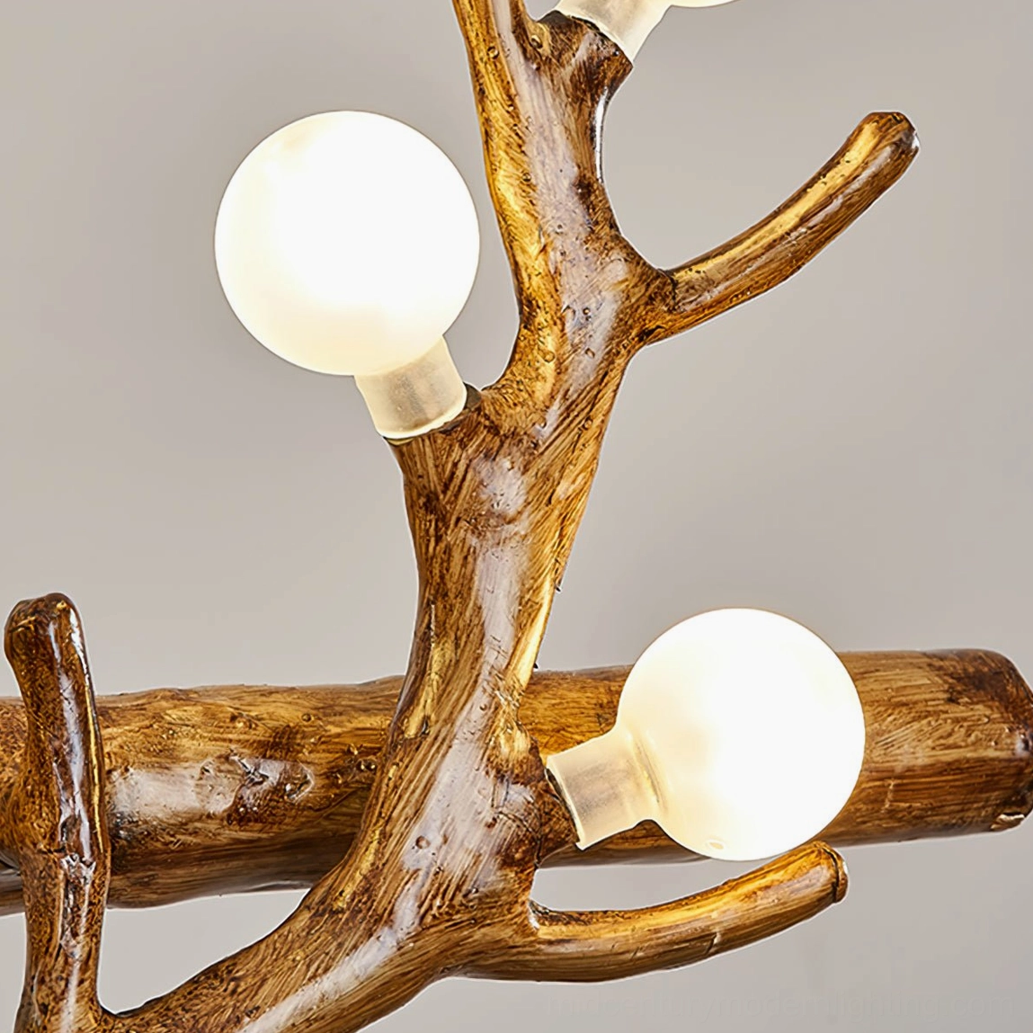 Macro close-up of frosted spherical glass bulbs on antler chandelier with warm light diffusion