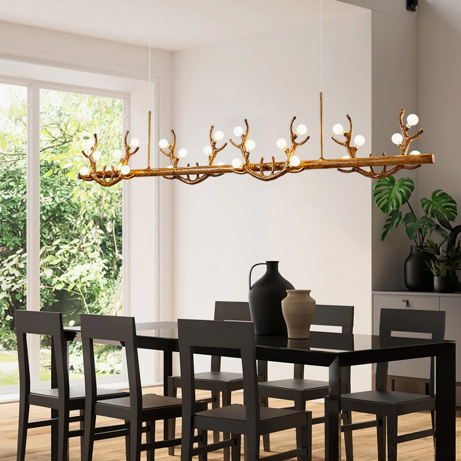 Full linear antler chandelier wide side perspective view in sunlit dining room with natural outdoor greenery backdrop