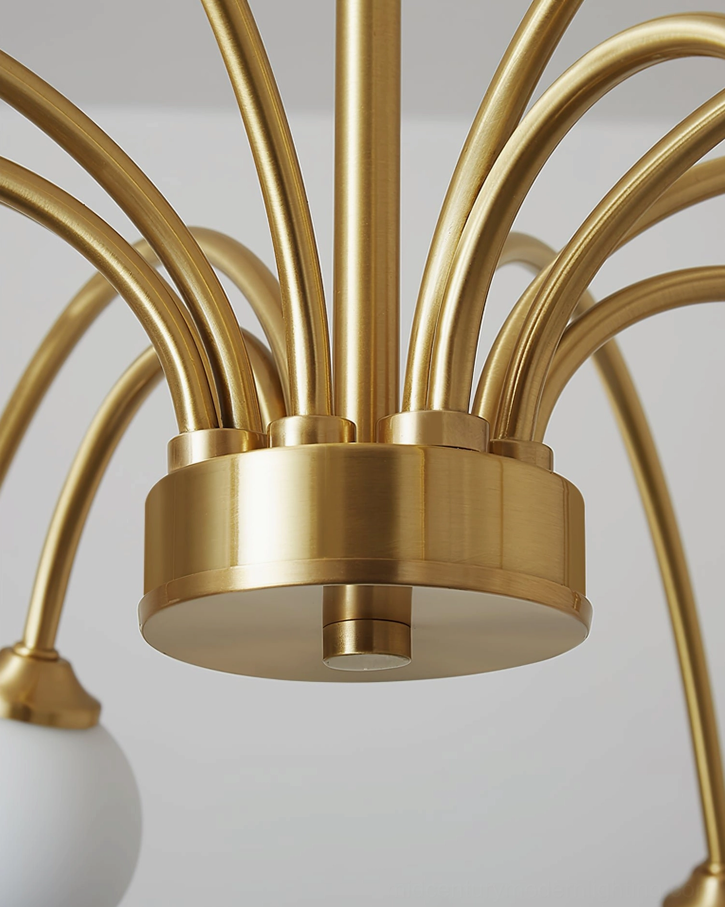 Detailed close-up of Apiales chandelier brass frame and curved arms with G9 socket construction