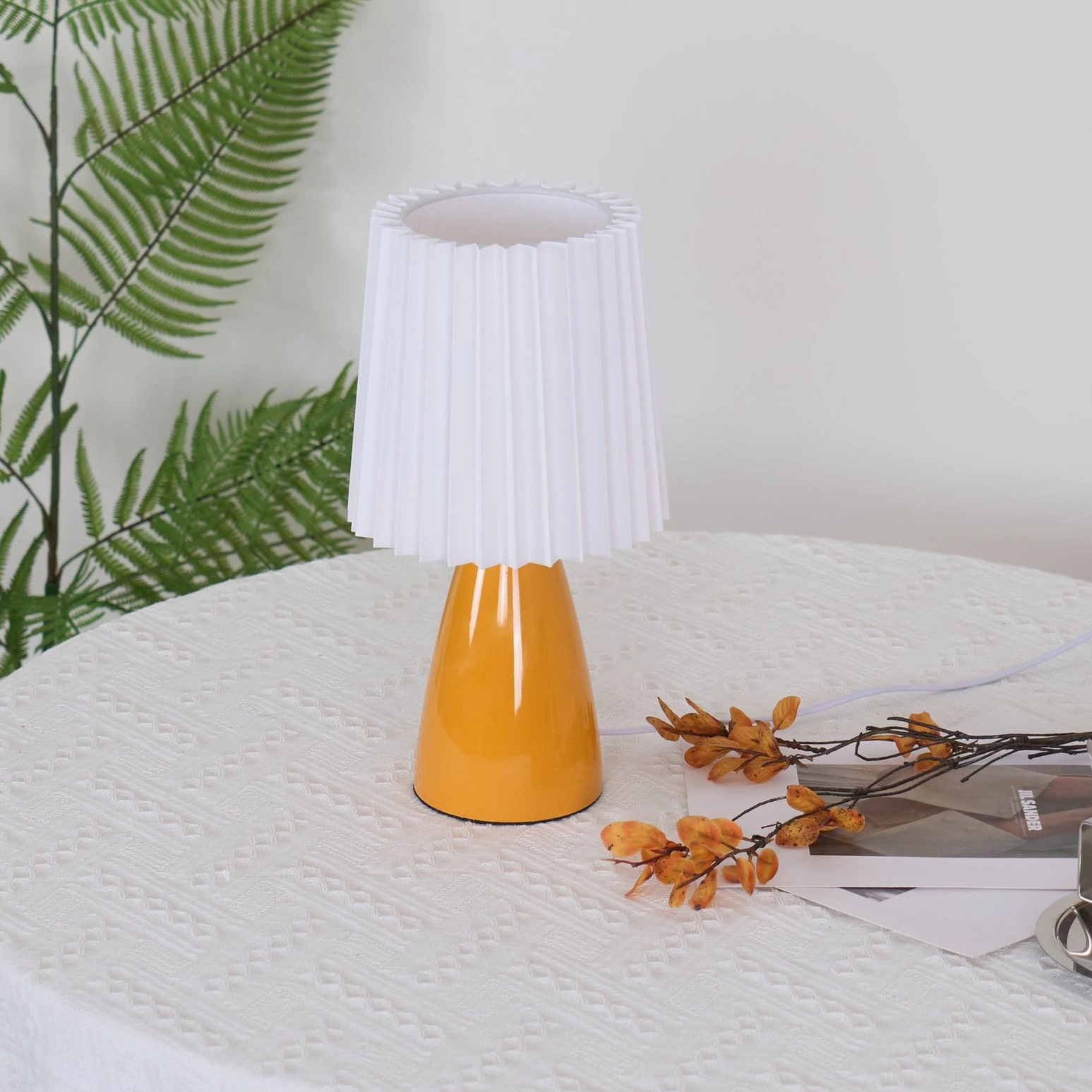 Apollo pleated table lamp with fern greenery, three-quarter front view unlit