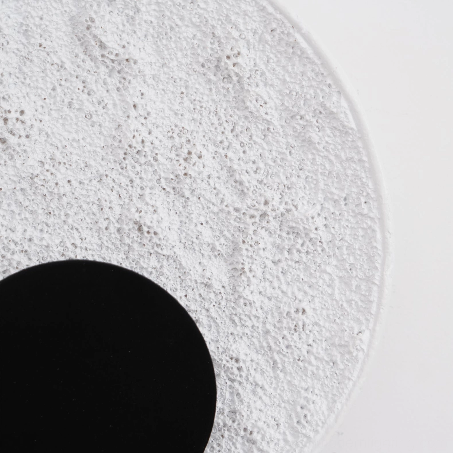 Apollo wall lamp extreme close-up porous lunar surface texture black circular center