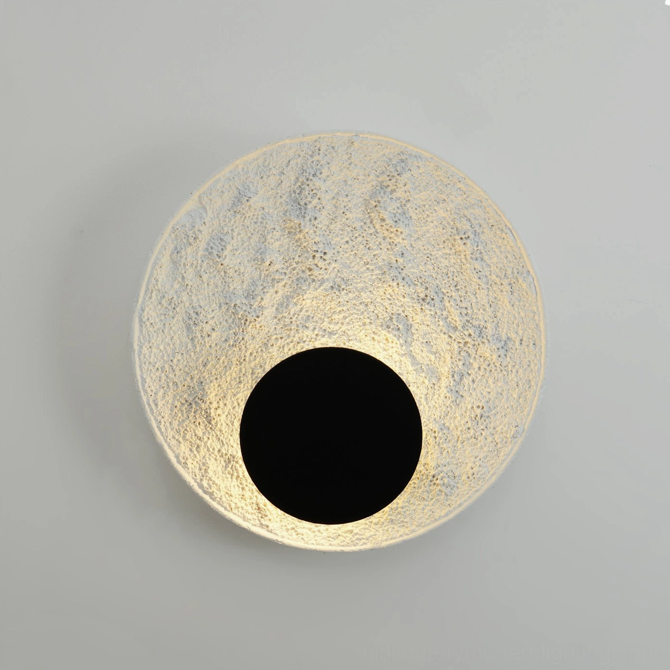 Apollo moon wall lamp illuminated warm glow textured surface close-up front view