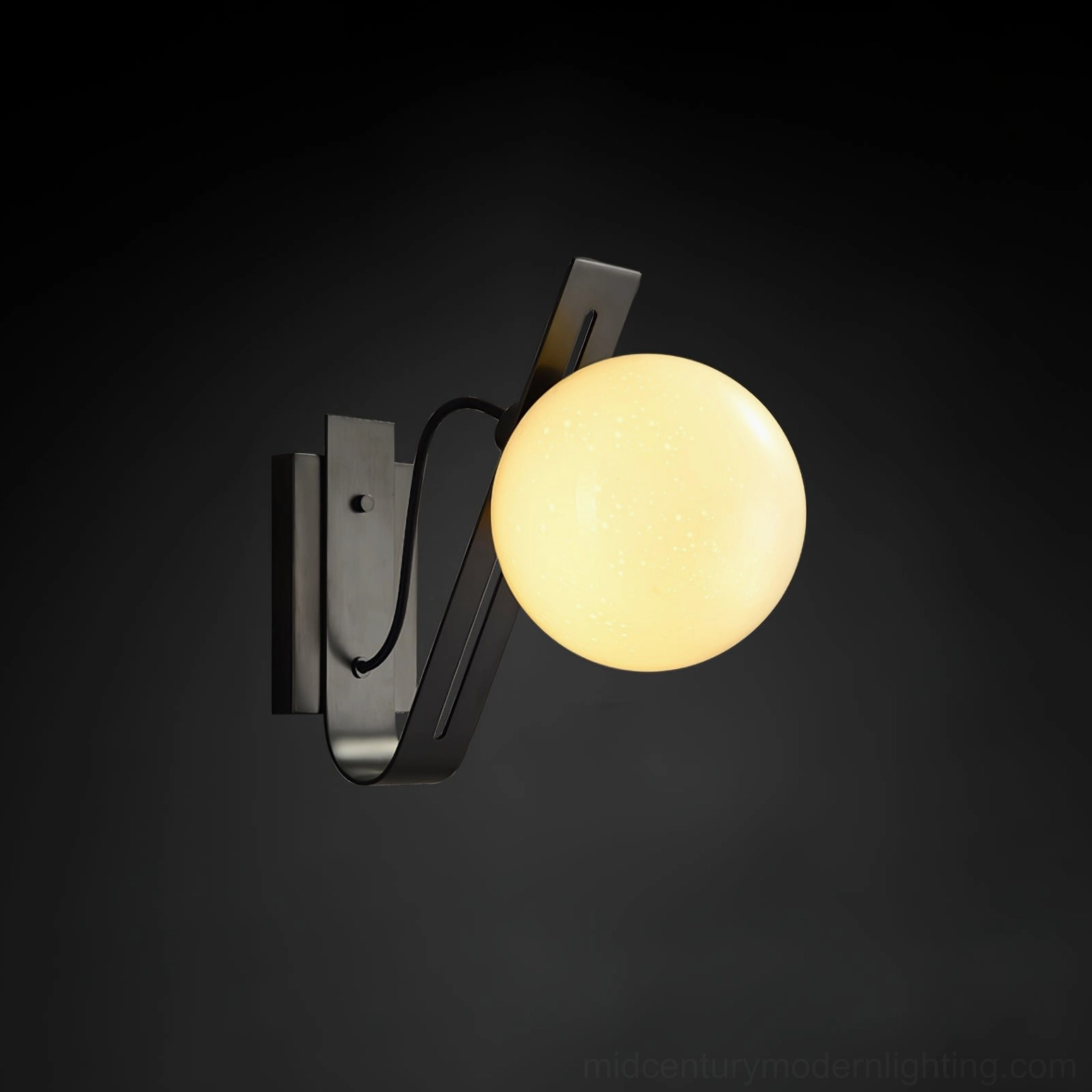 Illuminated black Arandela wall lamp with warm glowing frosted glass shade, modern decor