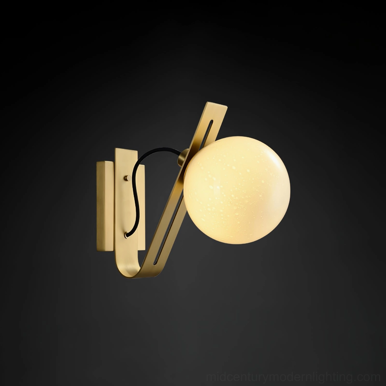 Lit brass Arandela globe wall sconce with warm ambient lighting effect in dark space