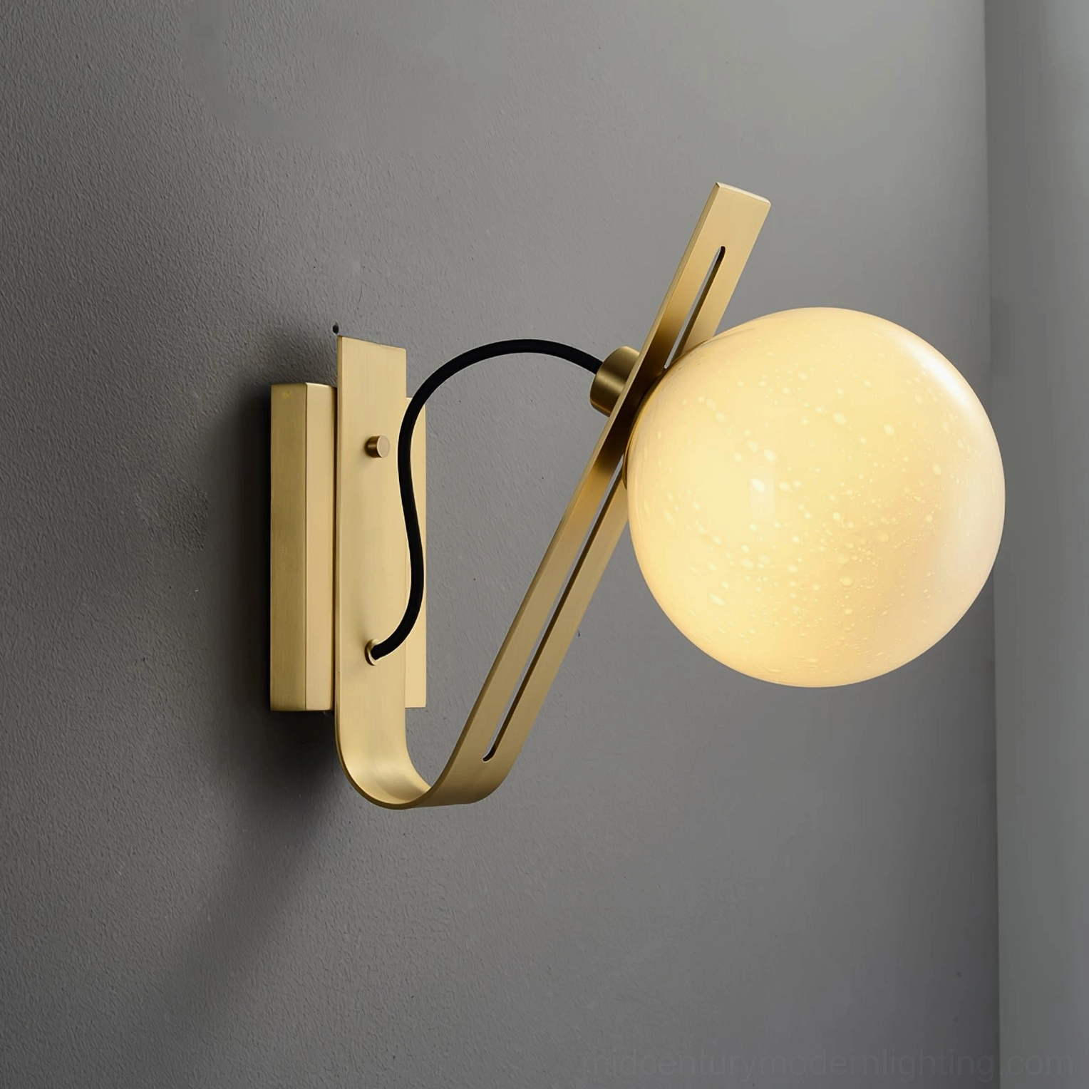 Arandela brass and white globe wall sconce providing warm task lighting in home office corner
