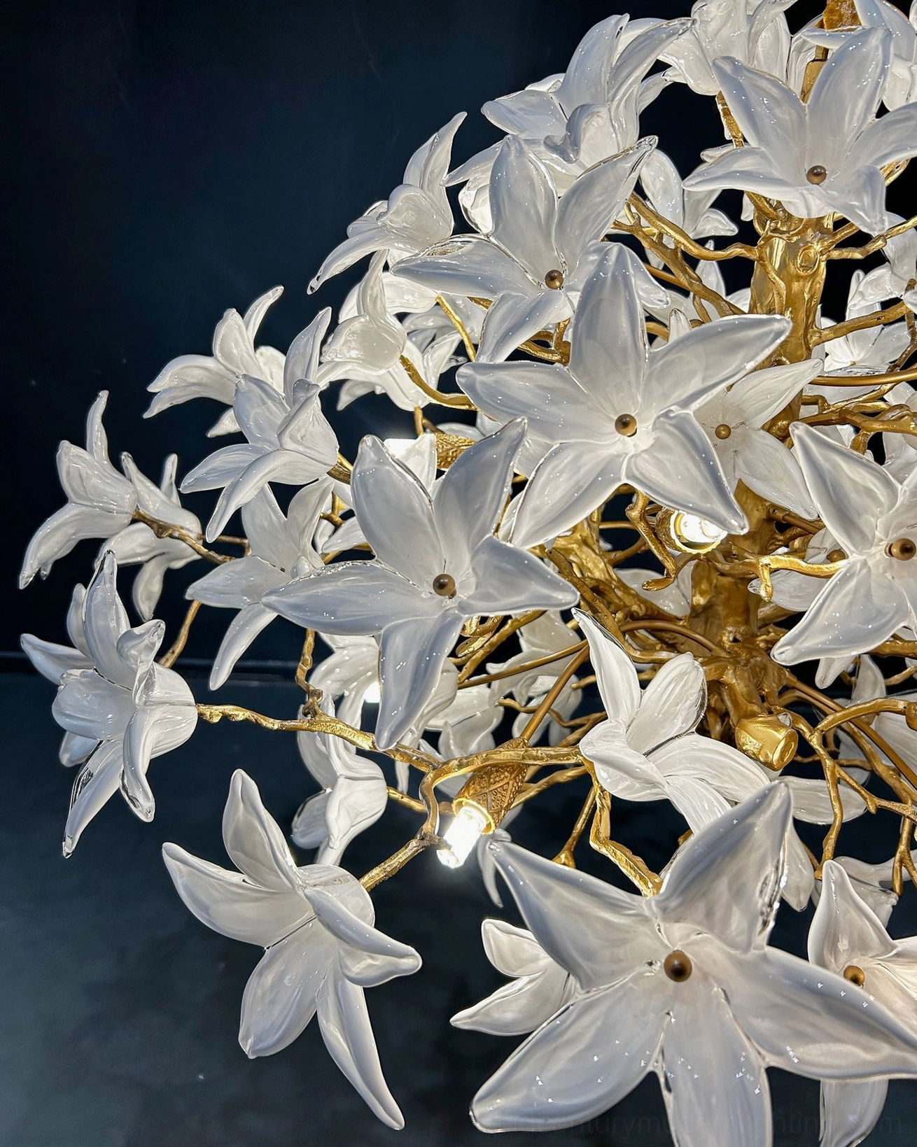 Arboris blossom branch chandelier architectural pendant with aircraft cable suspension over dining area