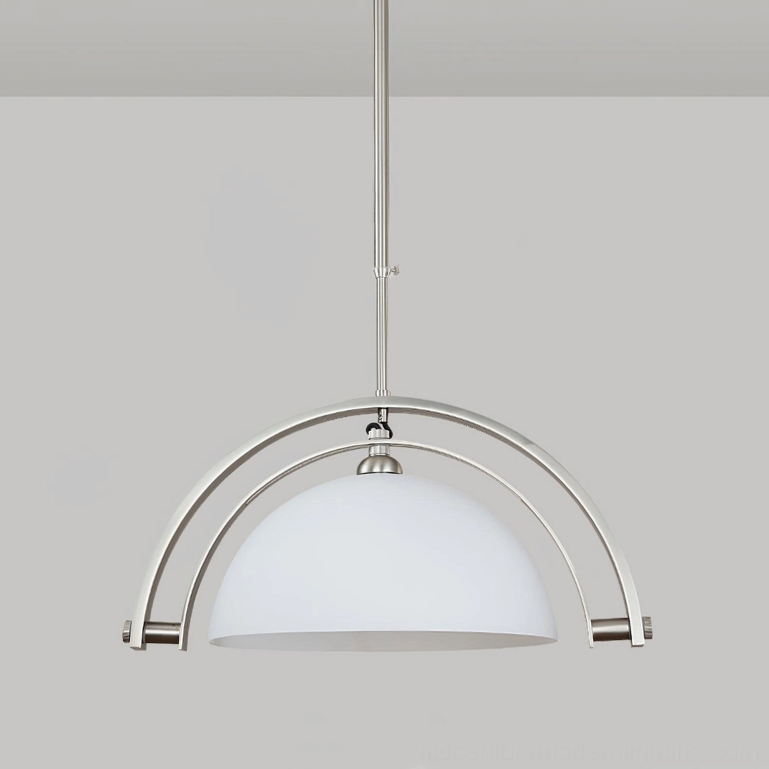 Arc pendant light with matte white shade and polished chrome frame in designer interior setting