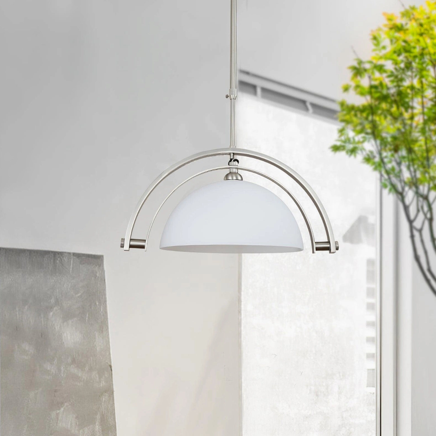 Arc pendant light side interior view in bright sunlit space with closed matte white shade and polished silver metal frame