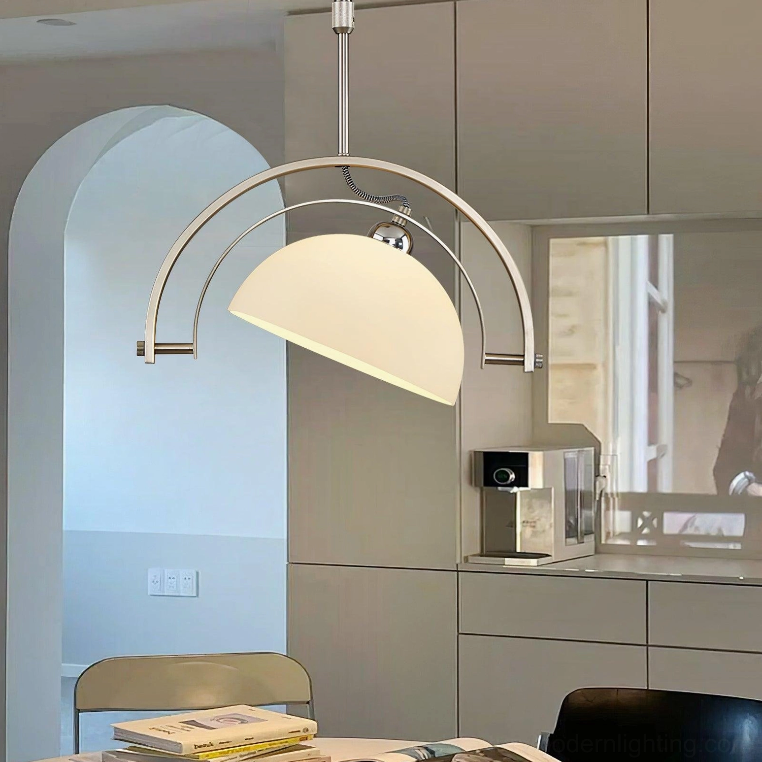 Arc pendant light in modern kitchen with arched doorway and neutral-toned minimalist Scandinavian aesthetic