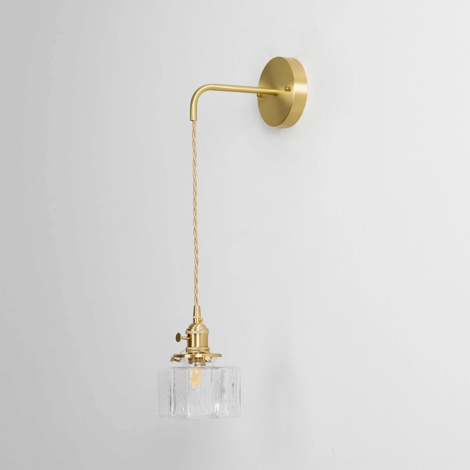 Architectural brass wall sconce with rippled glass shade modern interior design element
