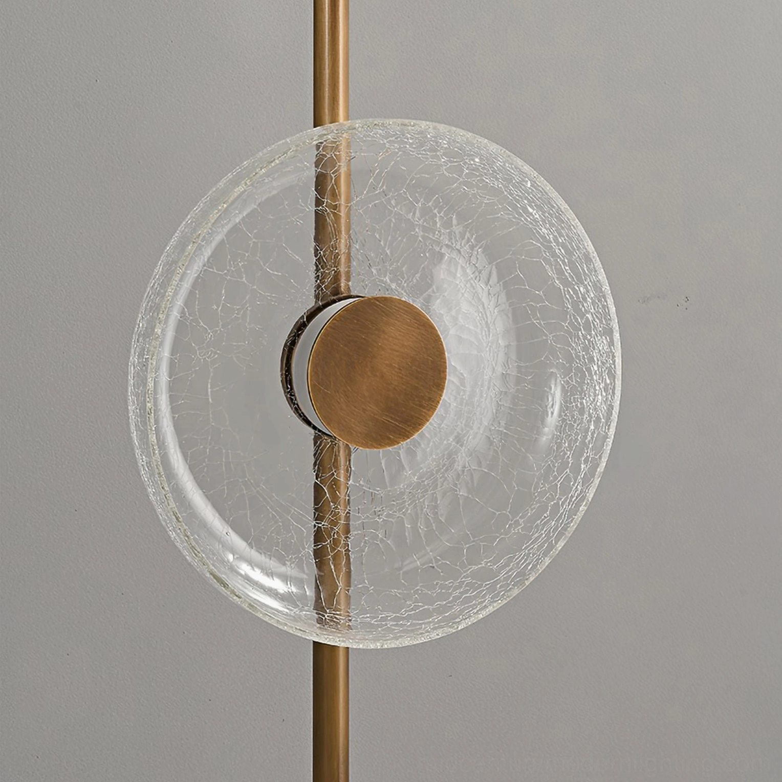 Architectural floor lamp featuring fractured crackle glass discs and weighted bronze base in studio setting