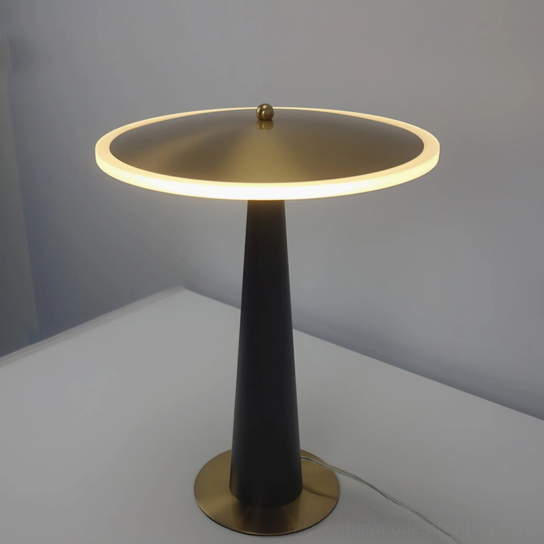 Minimalist black and gold drum table lamp architectural design study shot