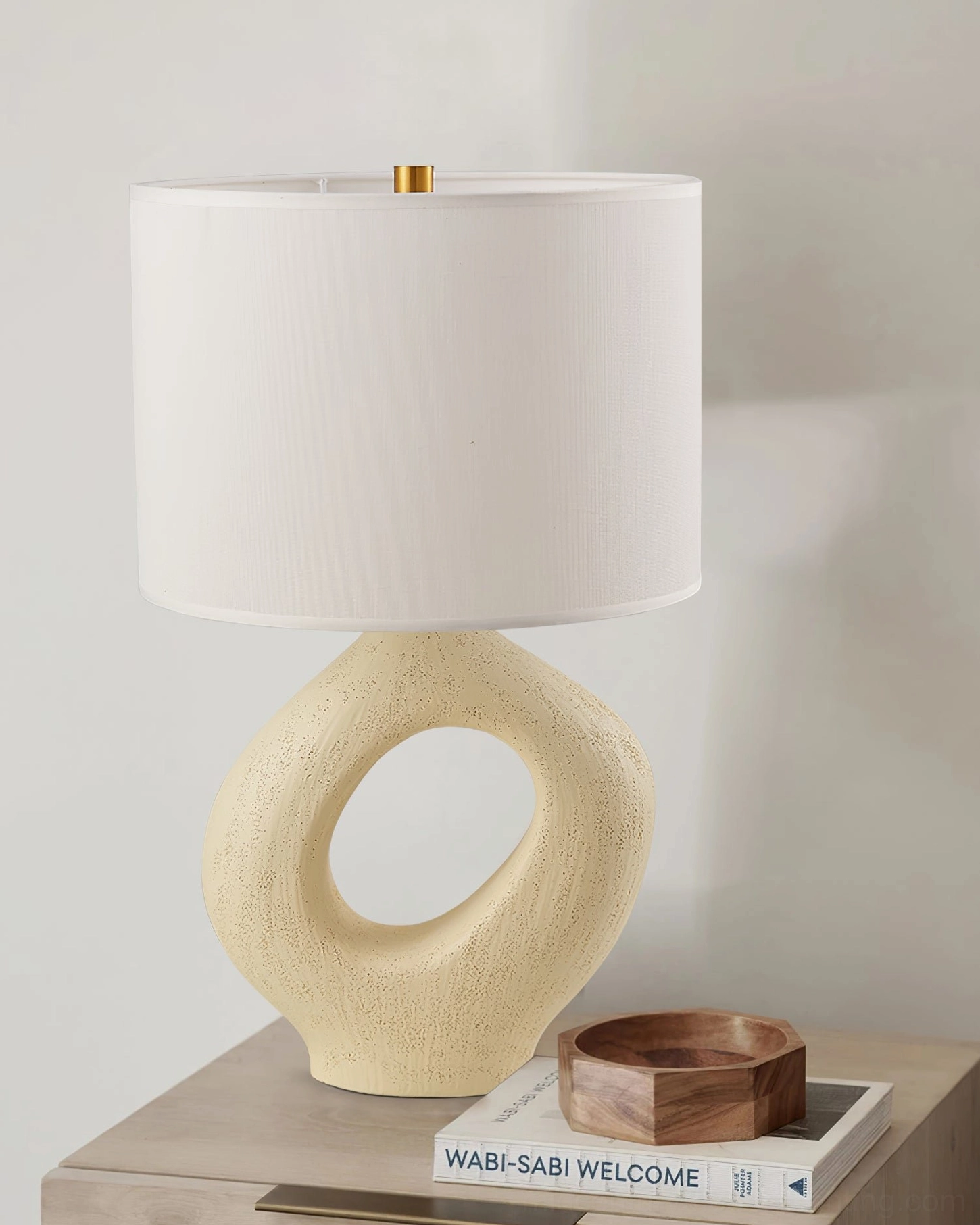 Modern sculptural table lamp with hollow ceramic resin base, architectural lighting piece for contemporary interiors