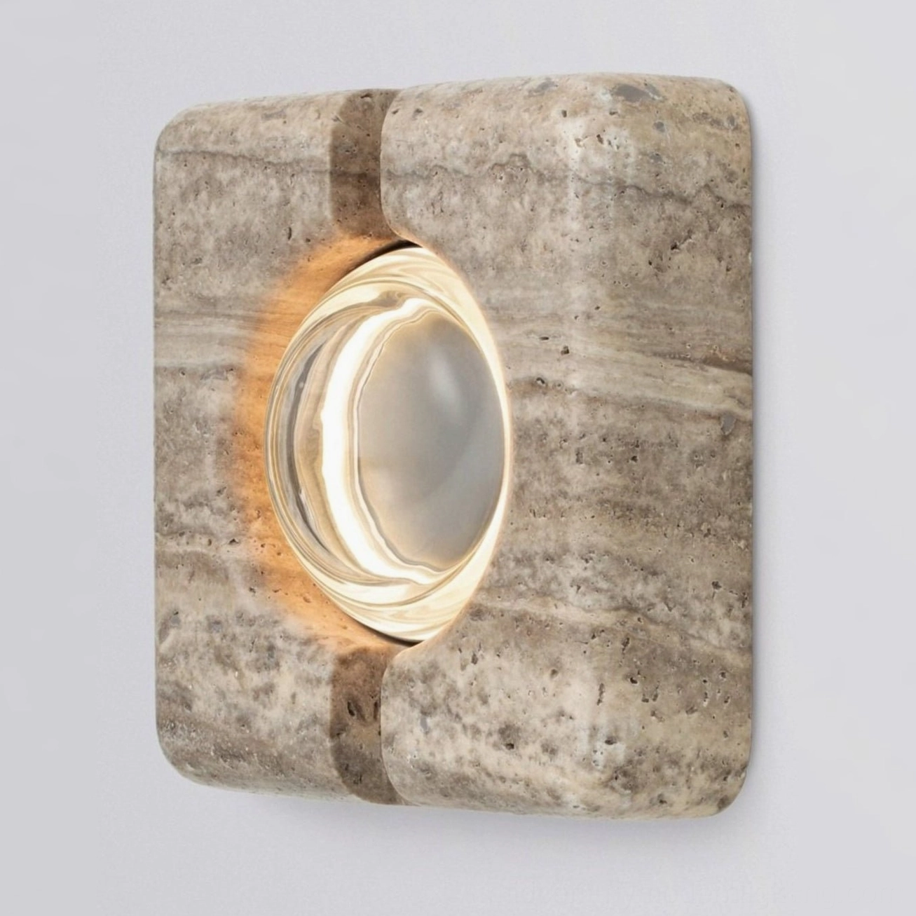 Architectural wall lamp combining travertine stone and LED technology for modern interiors