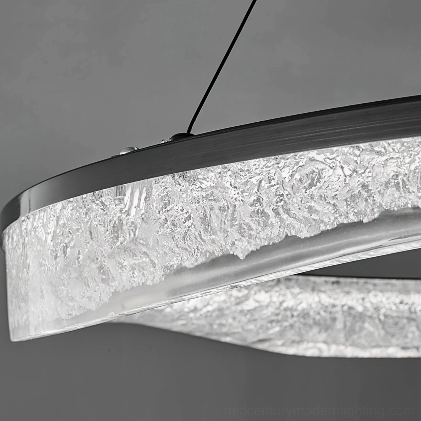 Single irregular ring pendant shade close-up showing rippled frosted texture