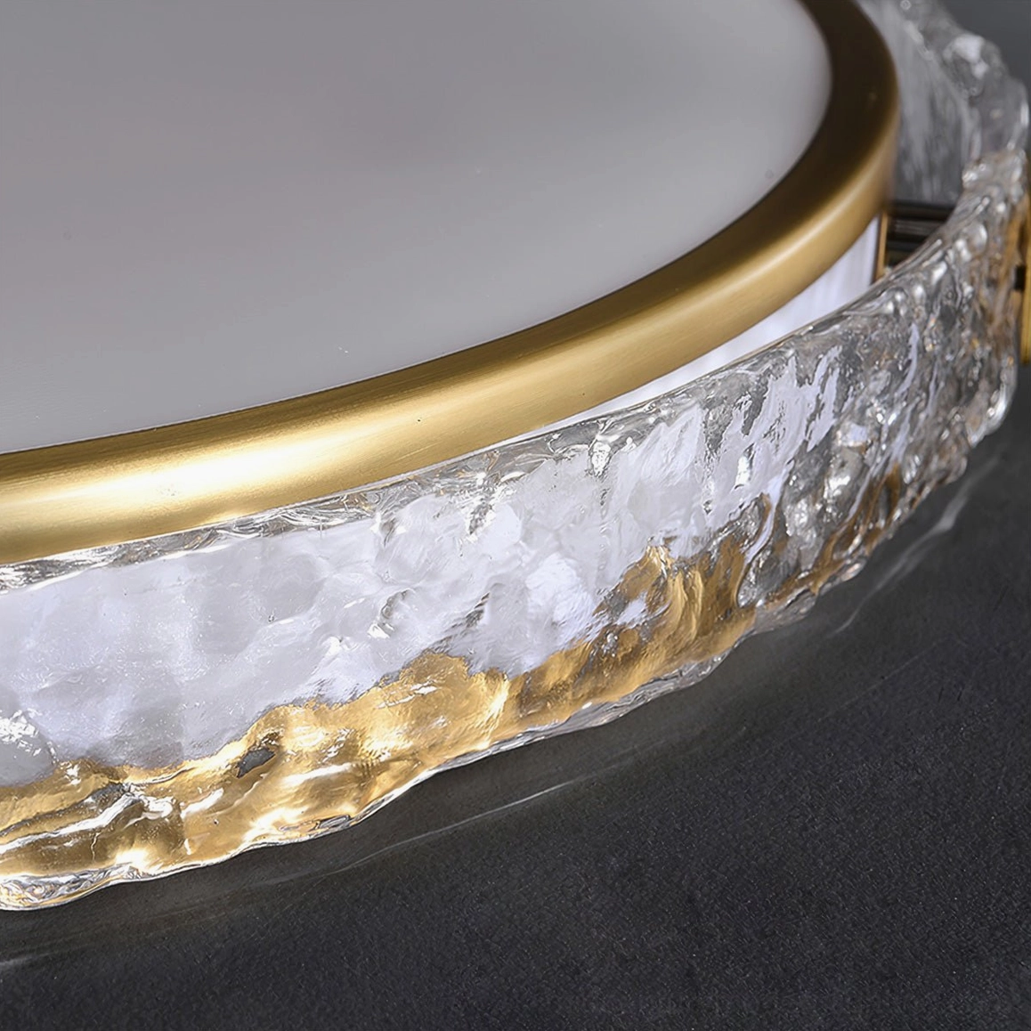 Close-up detail of Arlus ceiling lamp showing ice-cracked textured glass and gold brass ring accent