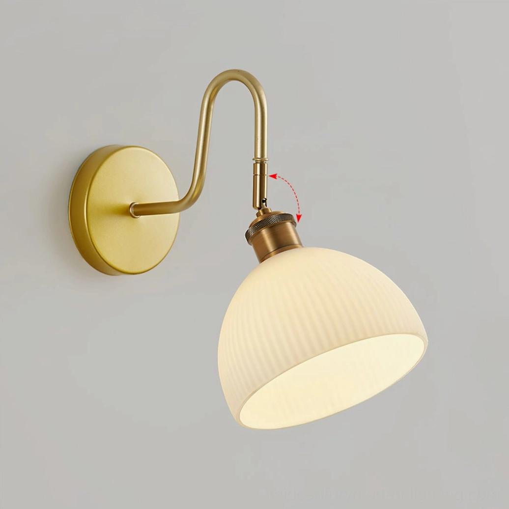 Arren wall-mounted sconce with curved brass hardware in minimalist contemporary home design